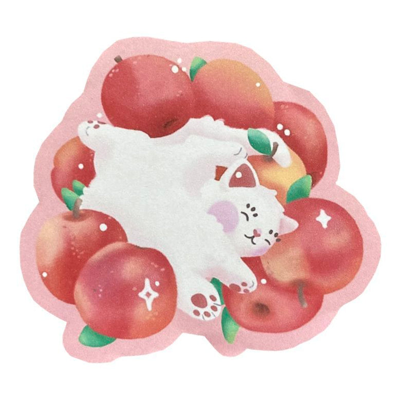 Photo of a sticker of a white cat lying amidst apples