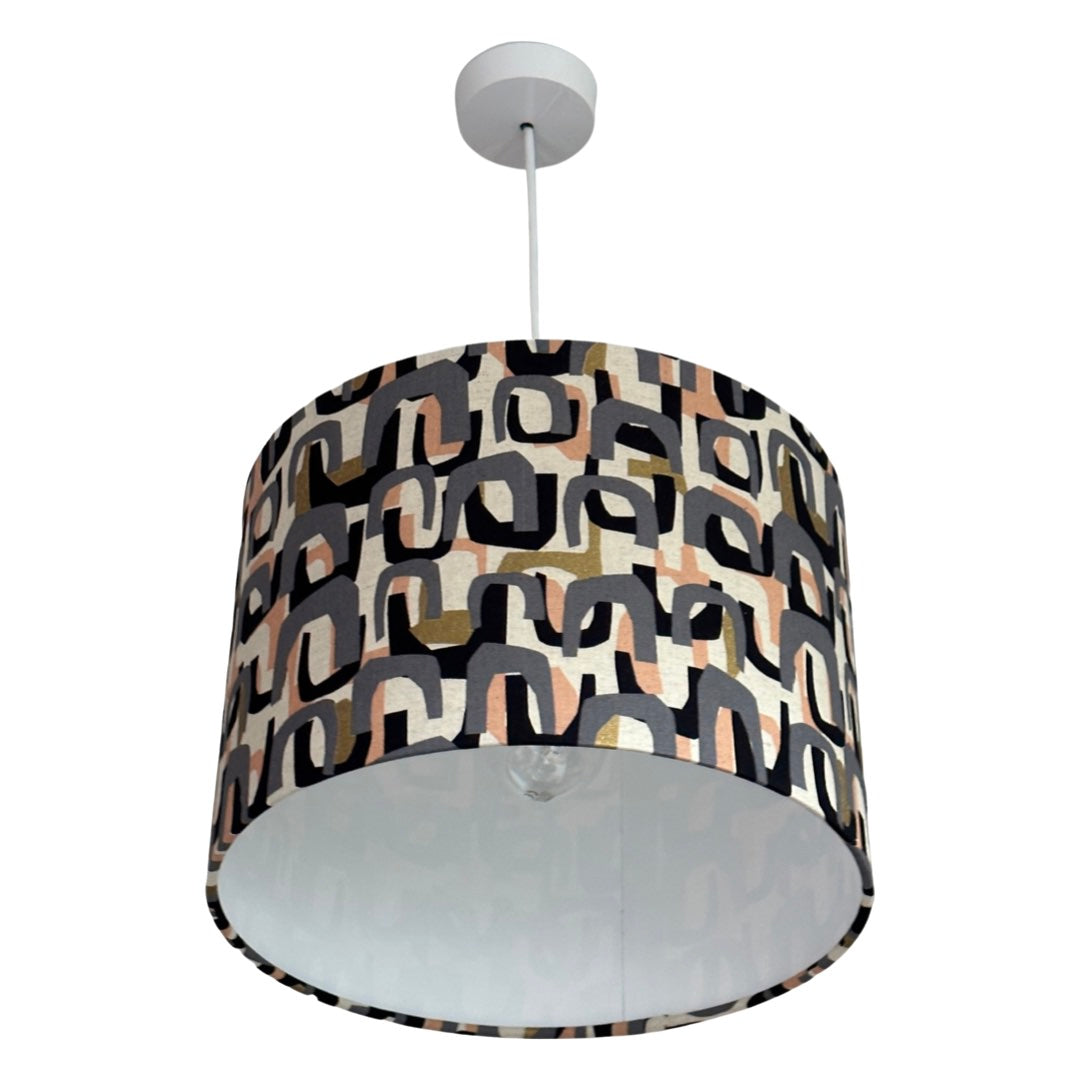 lampshade with a grey, peach, black and gold arch pattern