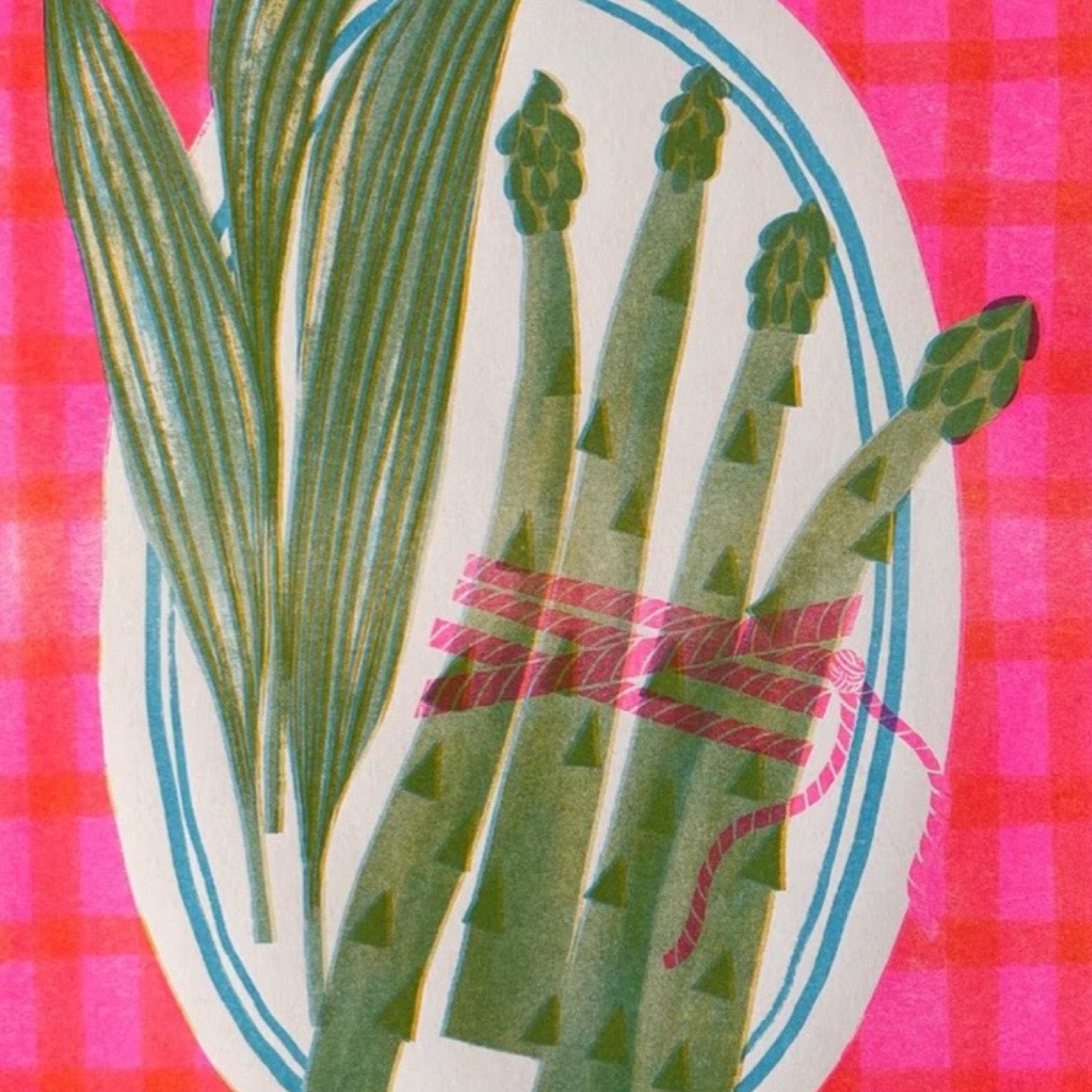 Illustration of green asparagus tied with pink ribbon on a pink checkered background.