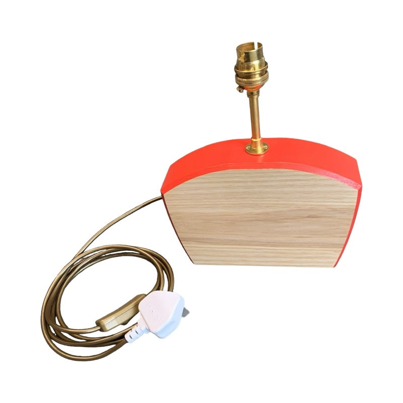 Shaped wooden lamp base with red edging and cable.