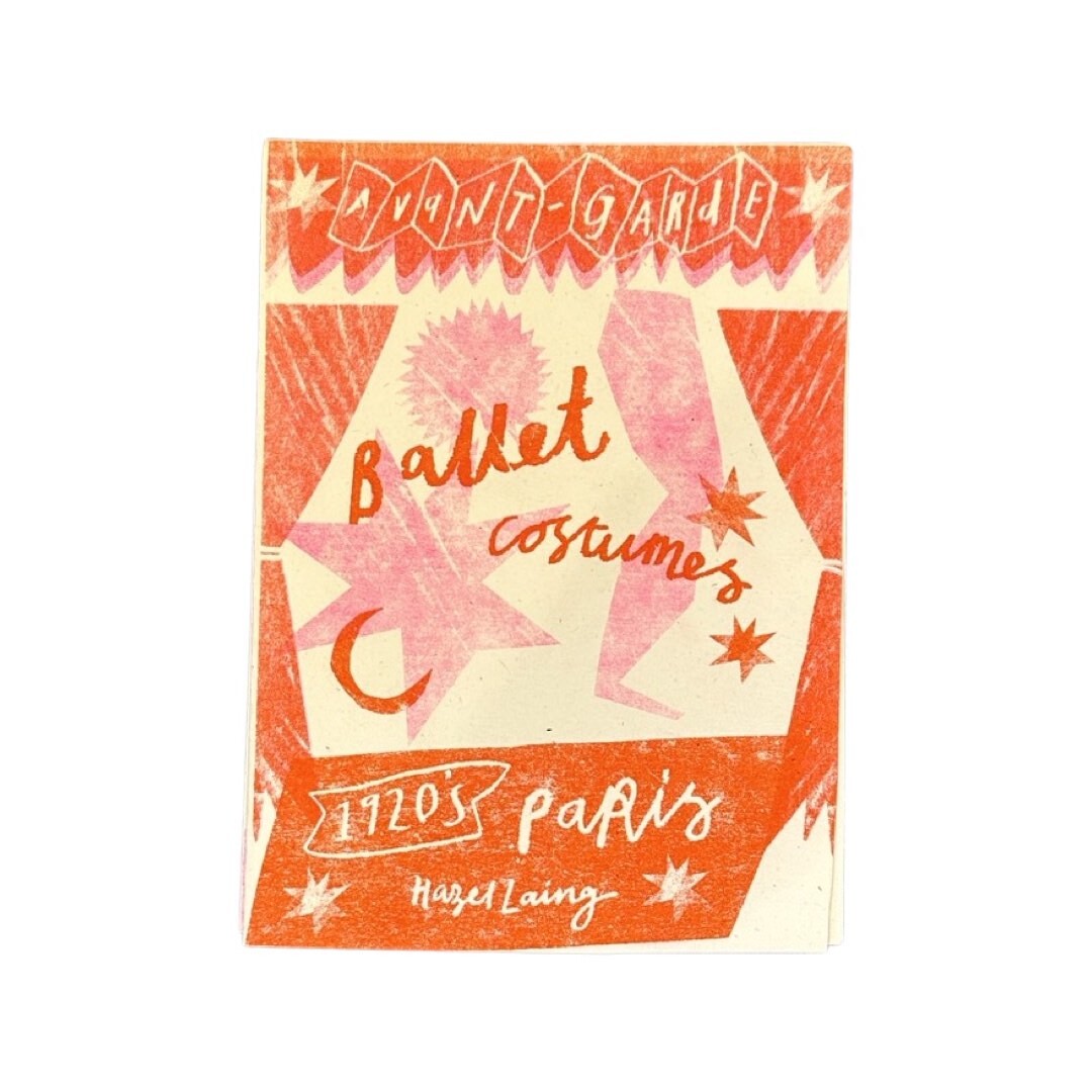 A folded ballet costumes zine in red and pink.