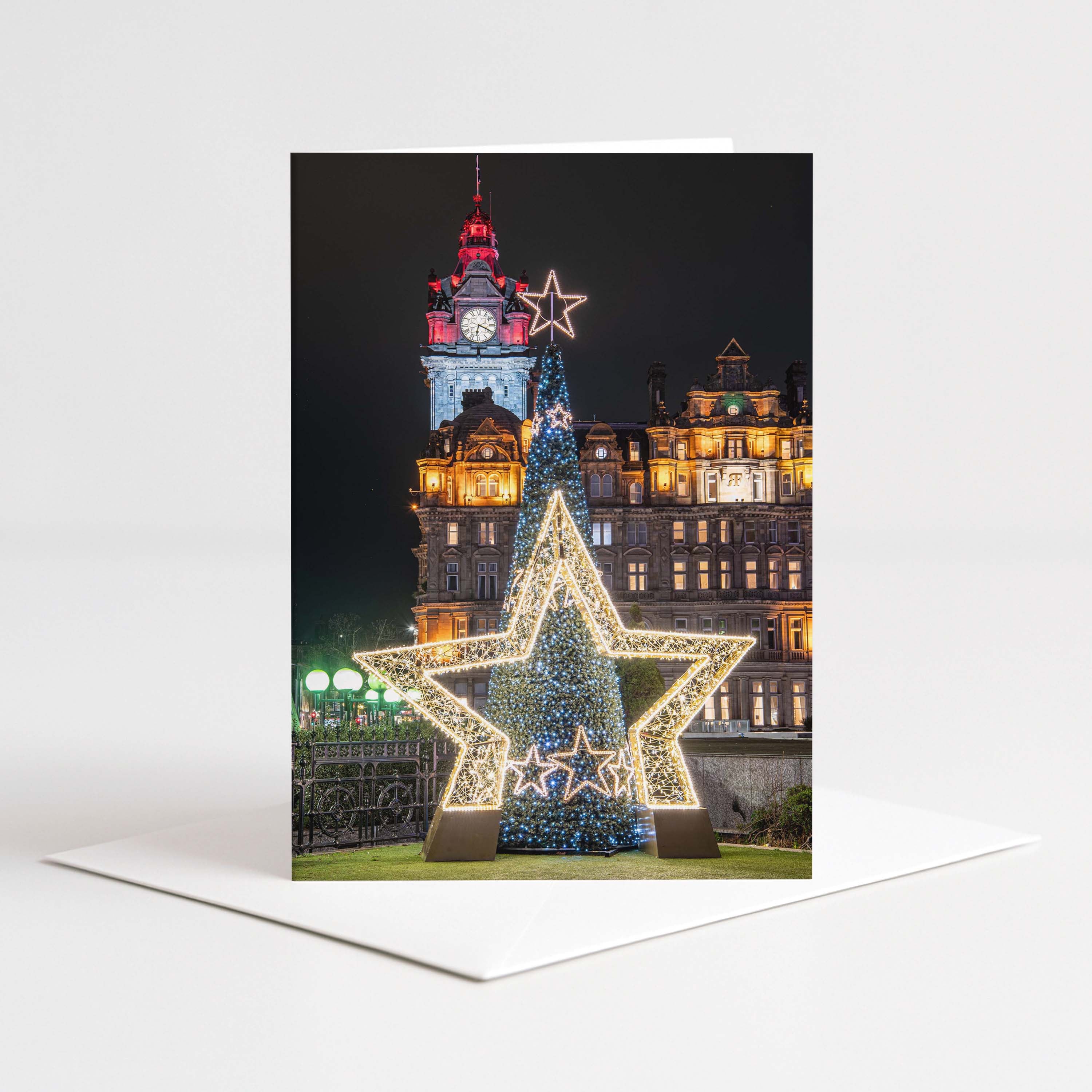 Decorative Christmas card with a large illuminated star and the Balmoral Hotel clock tower in the background.