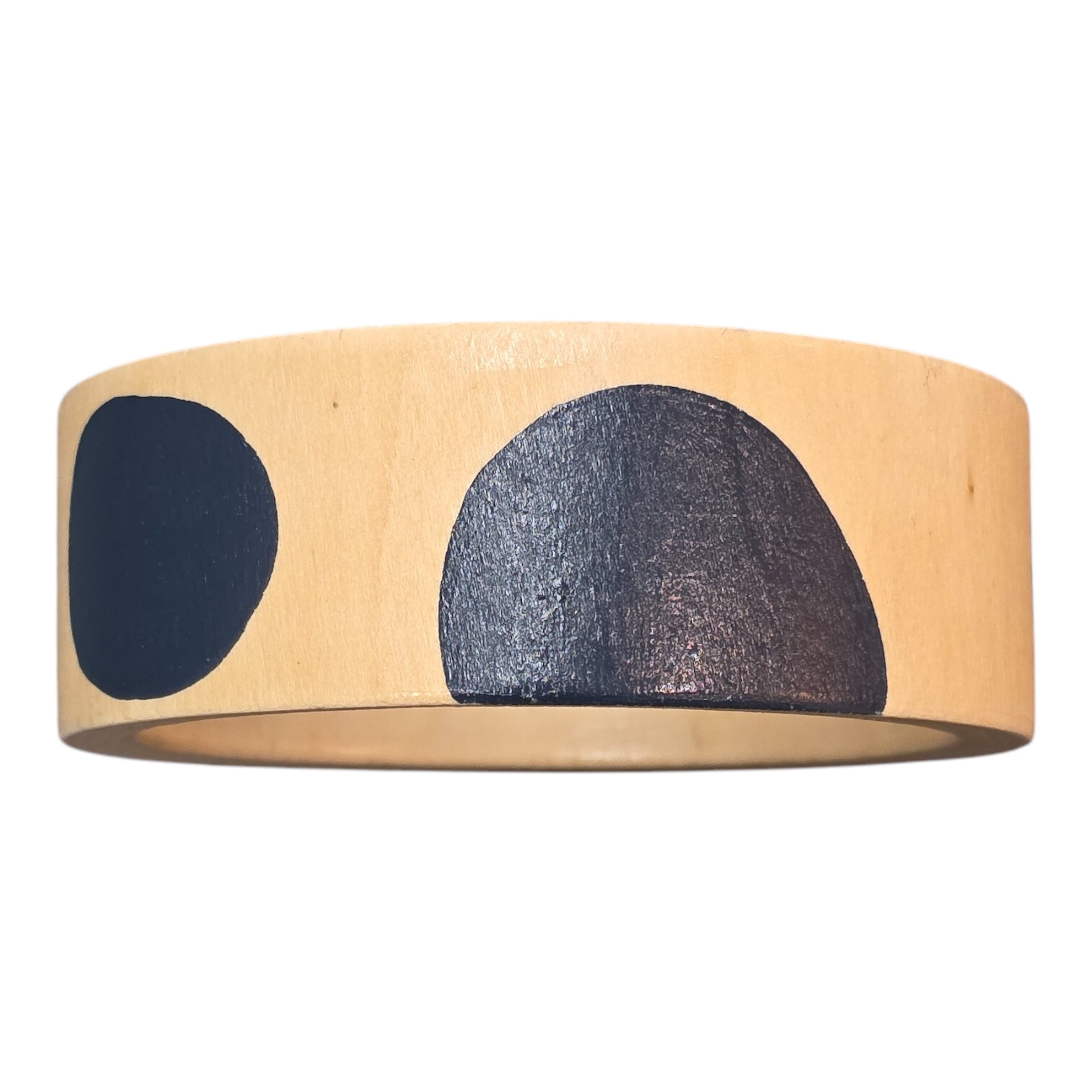 A bamboo wooden bangle with large blue polka dots.