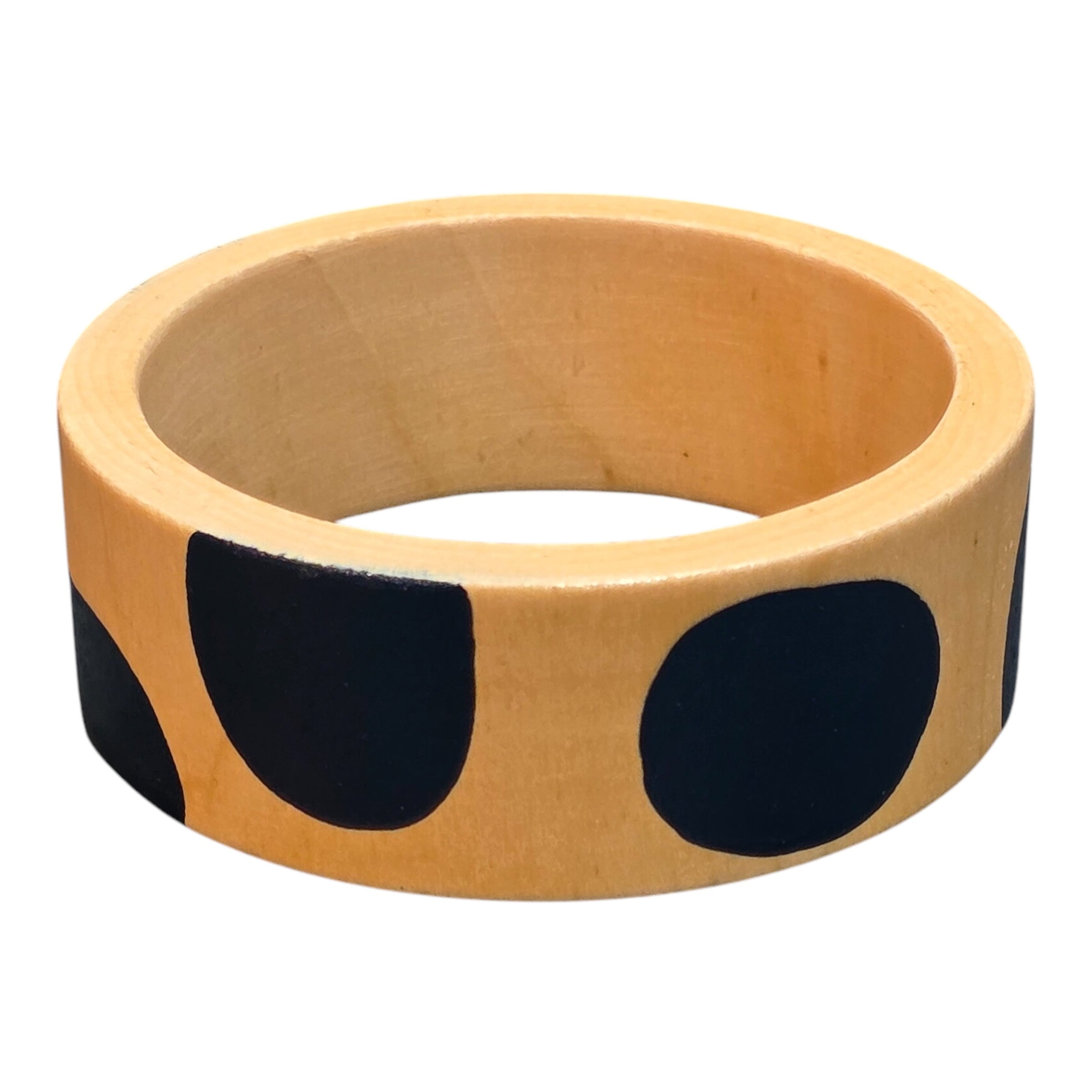 A bamboo wooden bangle with large blue polka dots.