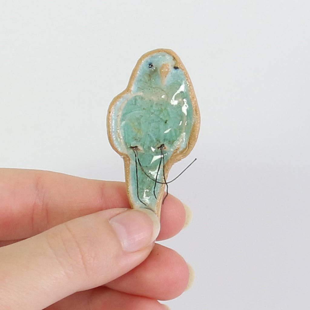 Blue plant hugger decoration handmade using British clay and recycled glass.