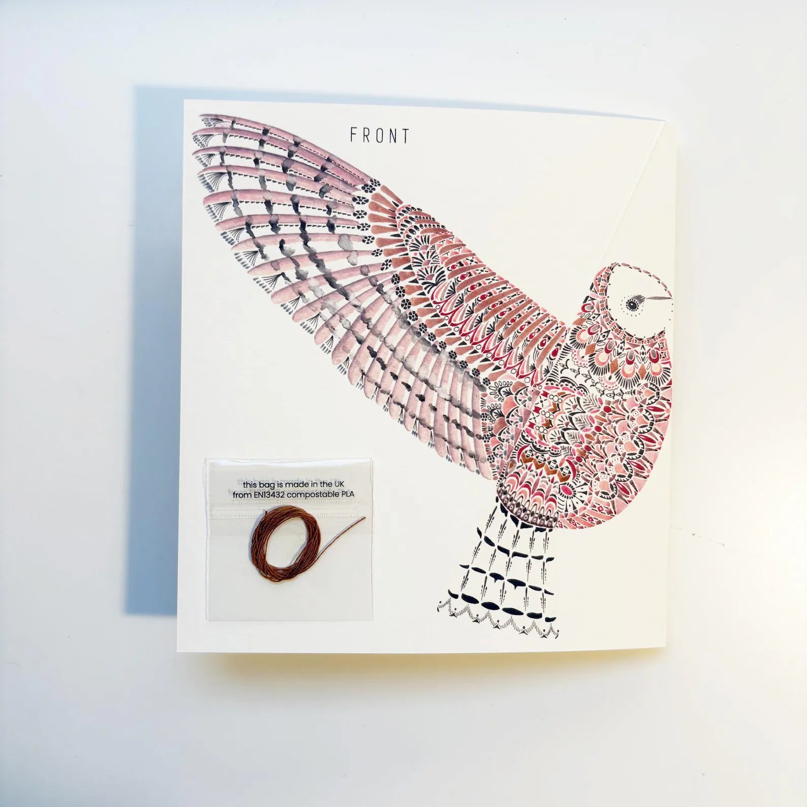 Card with a colorful bird design on a white background.