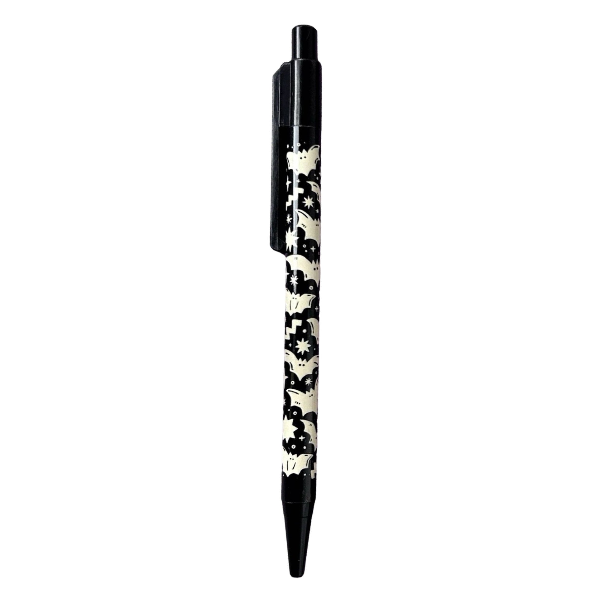 Ballpoint pen with a white bat design against a black background. 