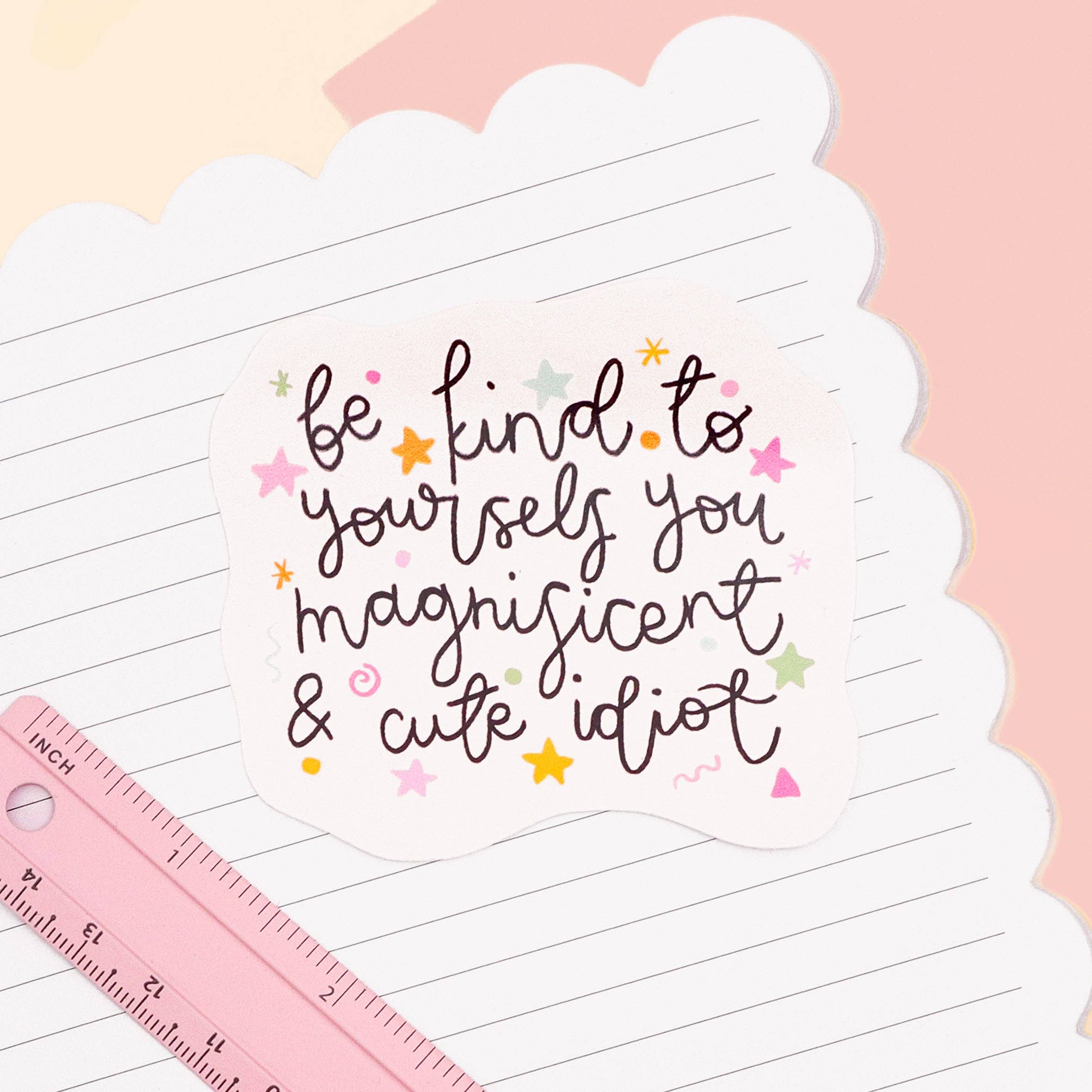 Motivational sticker with text on a lined paper background with a ruler.