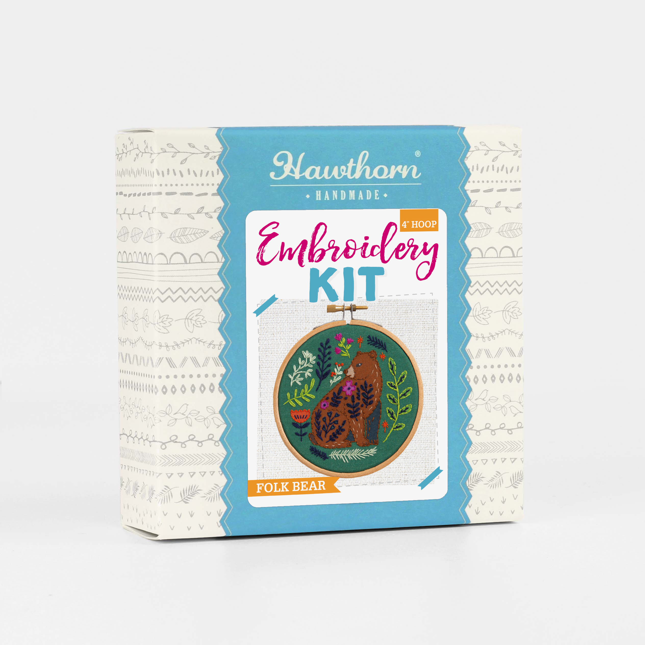 Embroidery kit packaging with bear design on a white background.