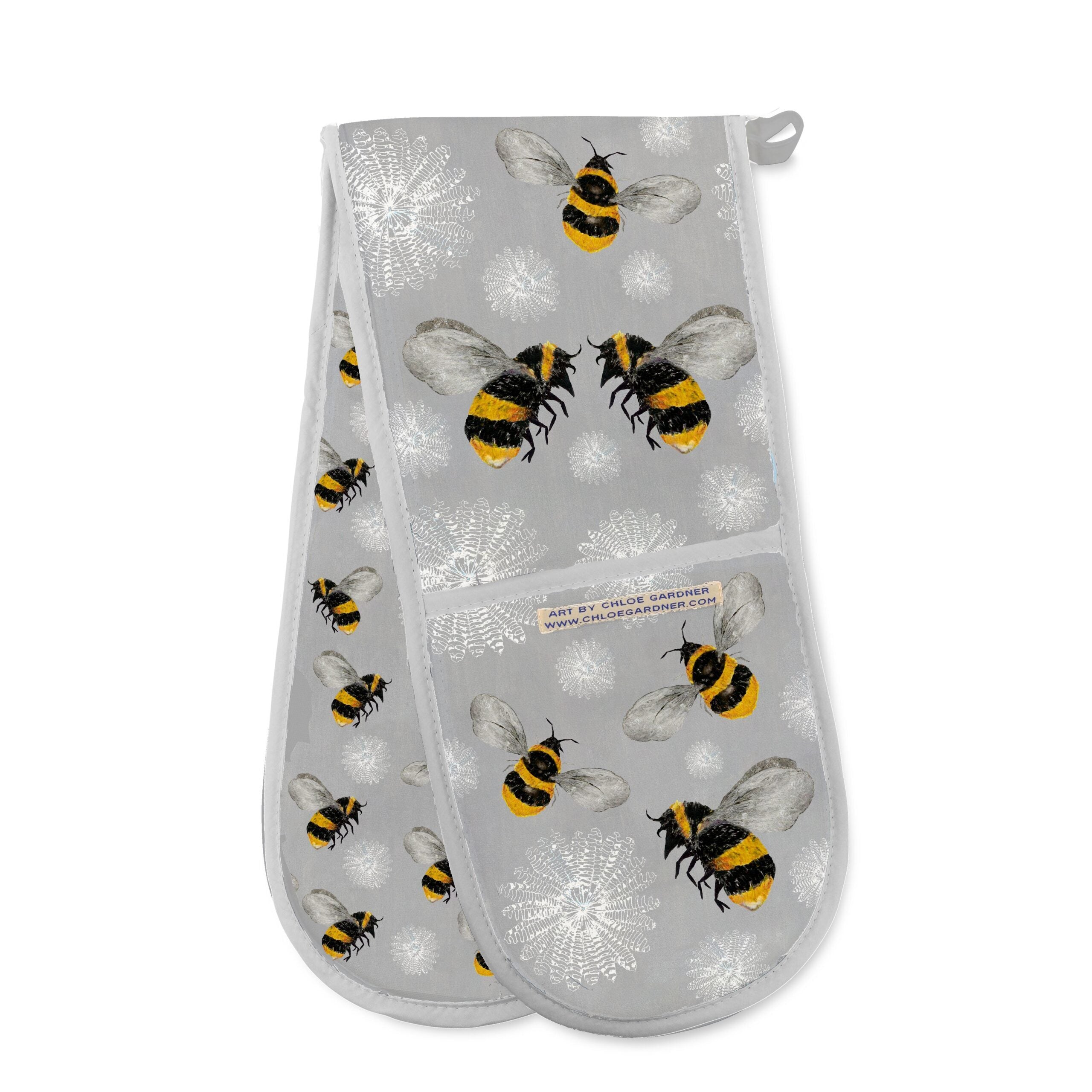 Grey oven gloves featuring flying bees and white flowers.