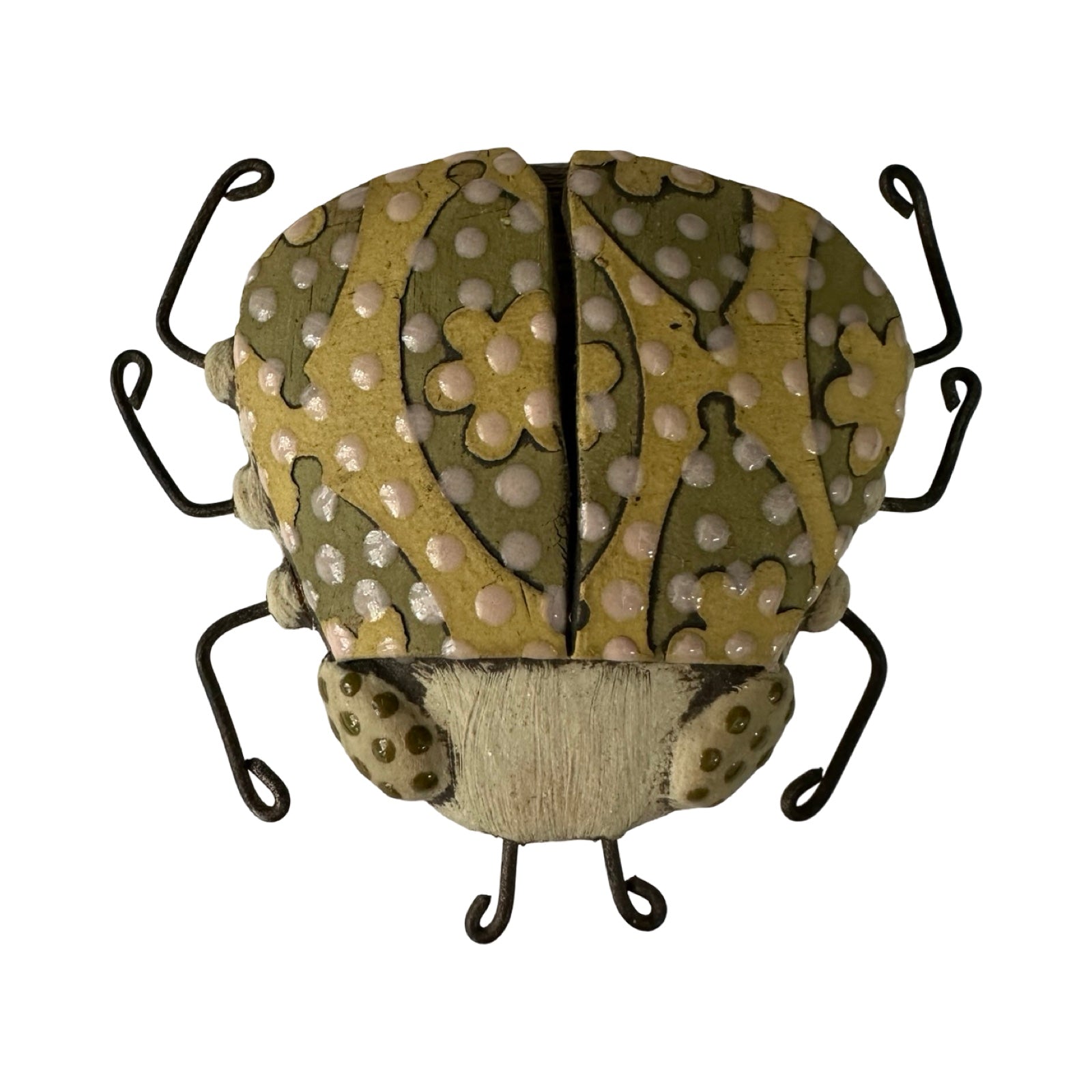 A small ceramic beetle with a green floral eye design and wire legs.