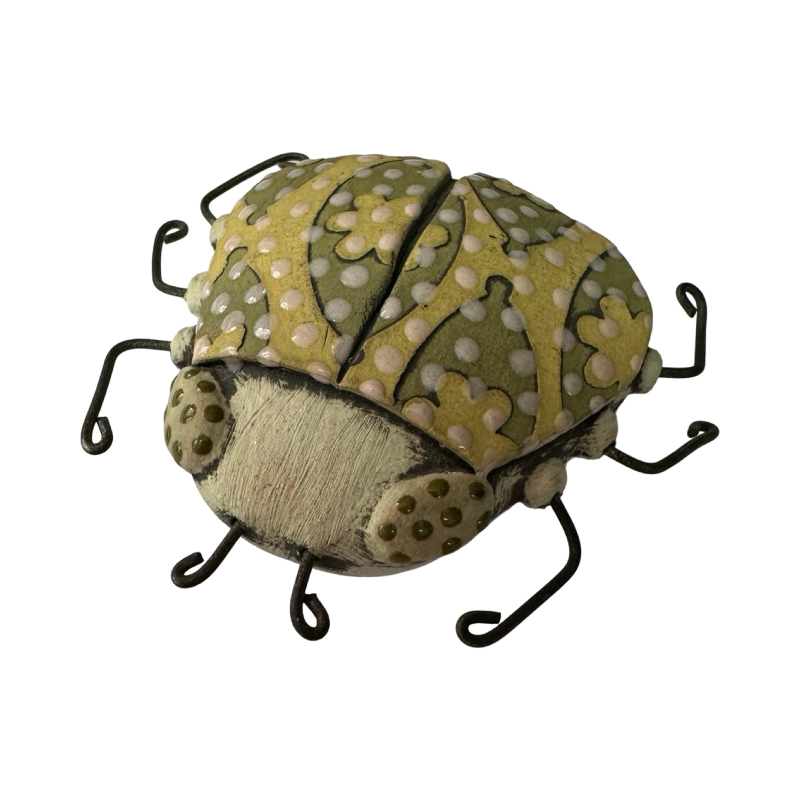 A small ceramic beetle with a green floral eye design and wire legs.