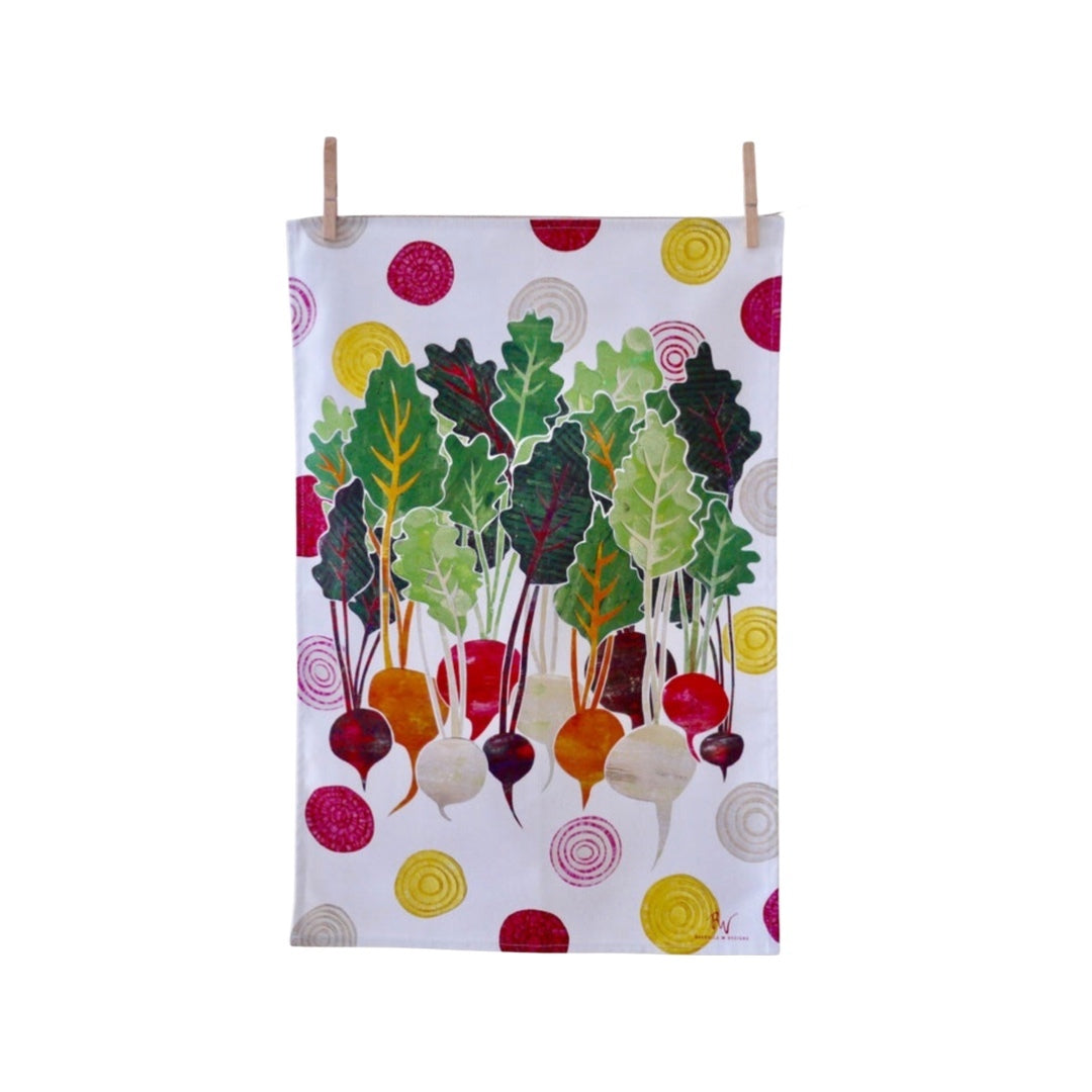 Beetroot tea towel with purple, pink, orange and cream beetroots with green leaves on a white background with colourful slices of beetroot.
