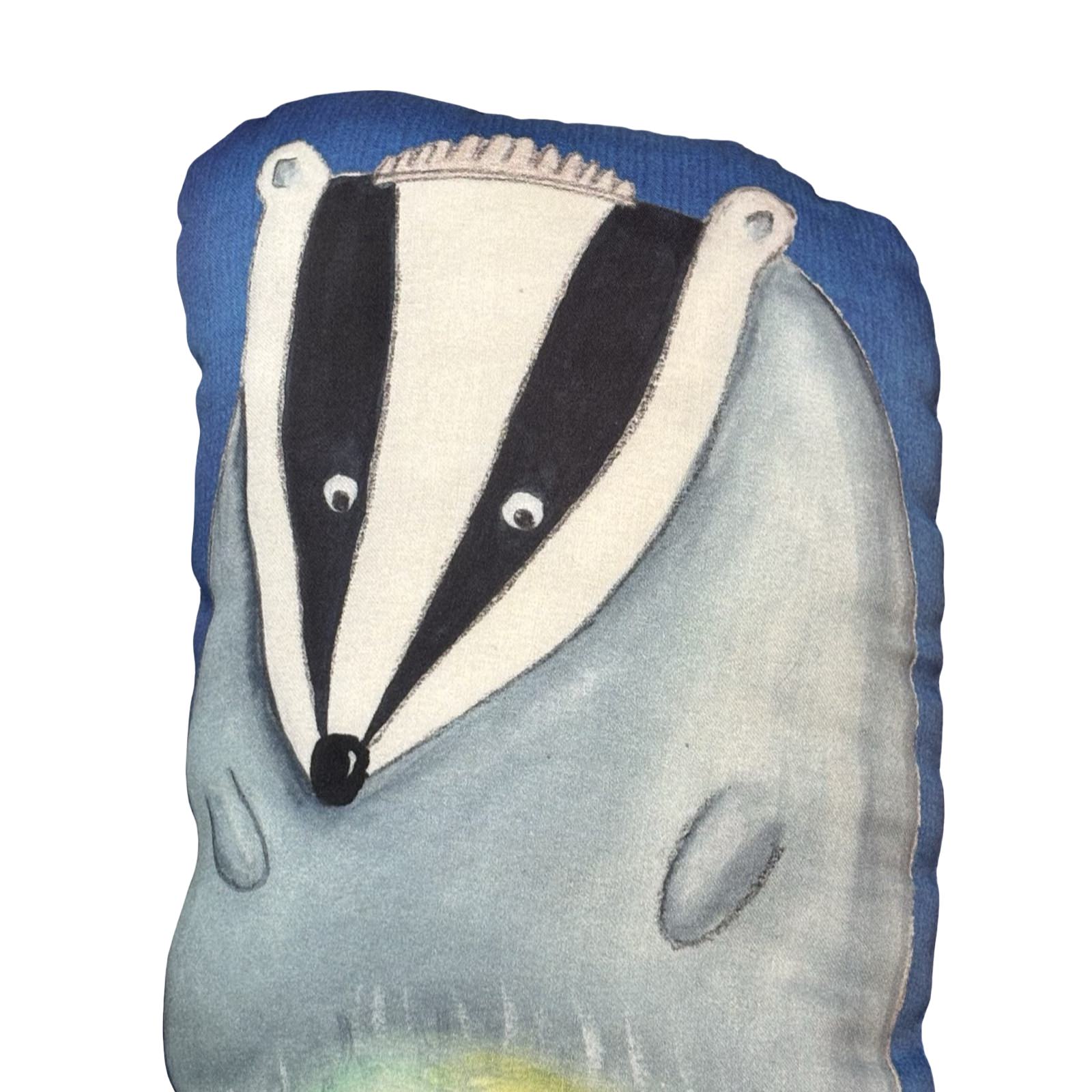 Badger-shaped cushion with blue background.