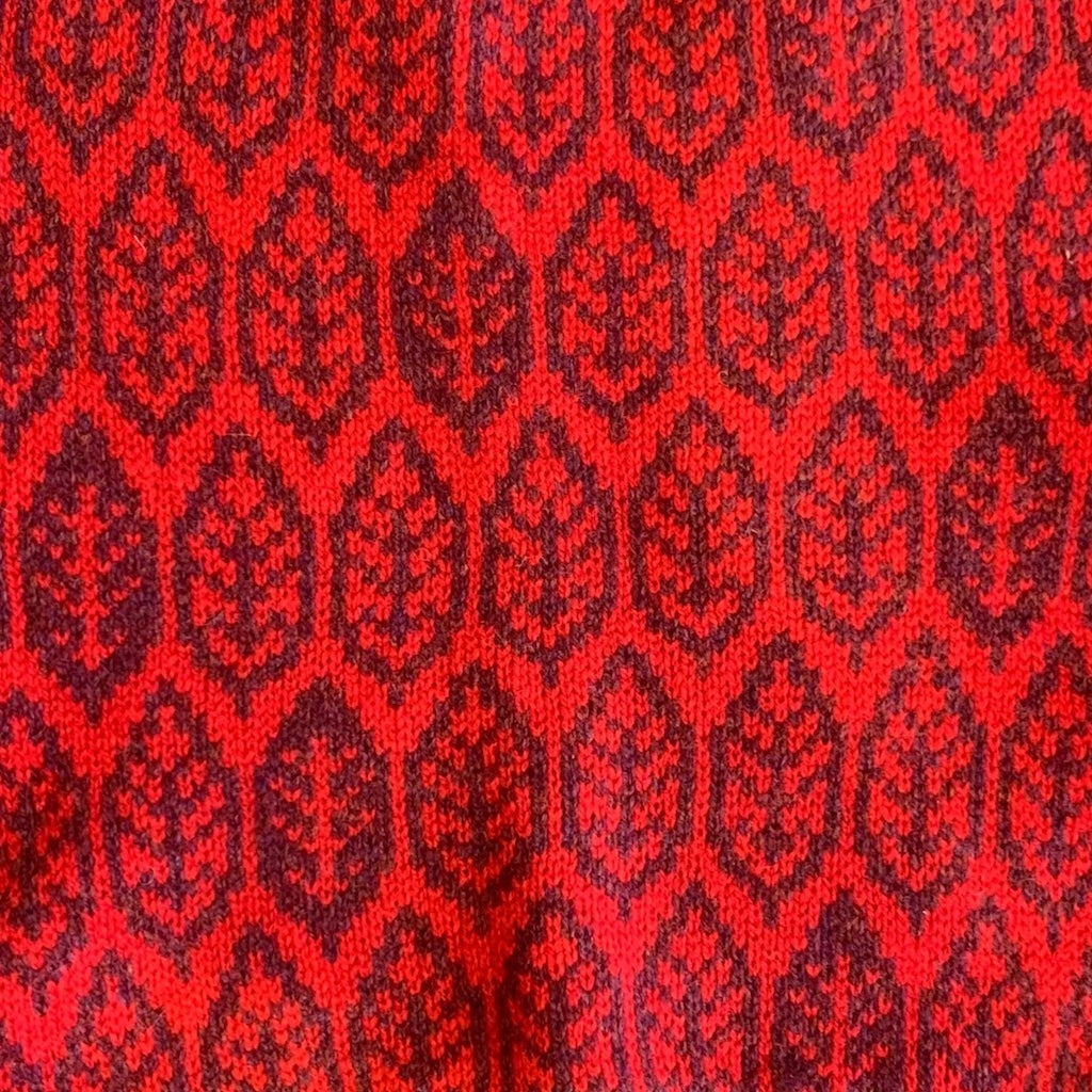 Red fabric with black geometric pattern.