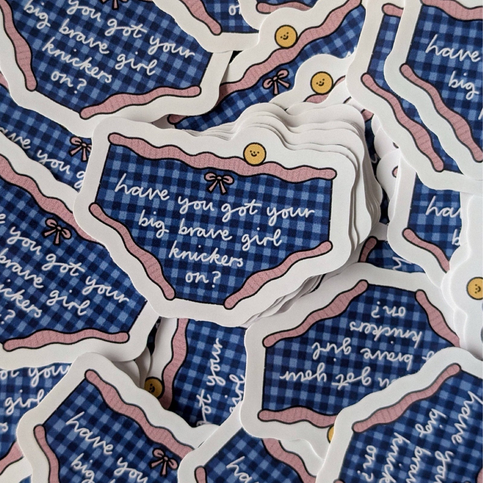 Sticker of checkered underwear with the text 'have you got your big brave girl knickers on?'.
