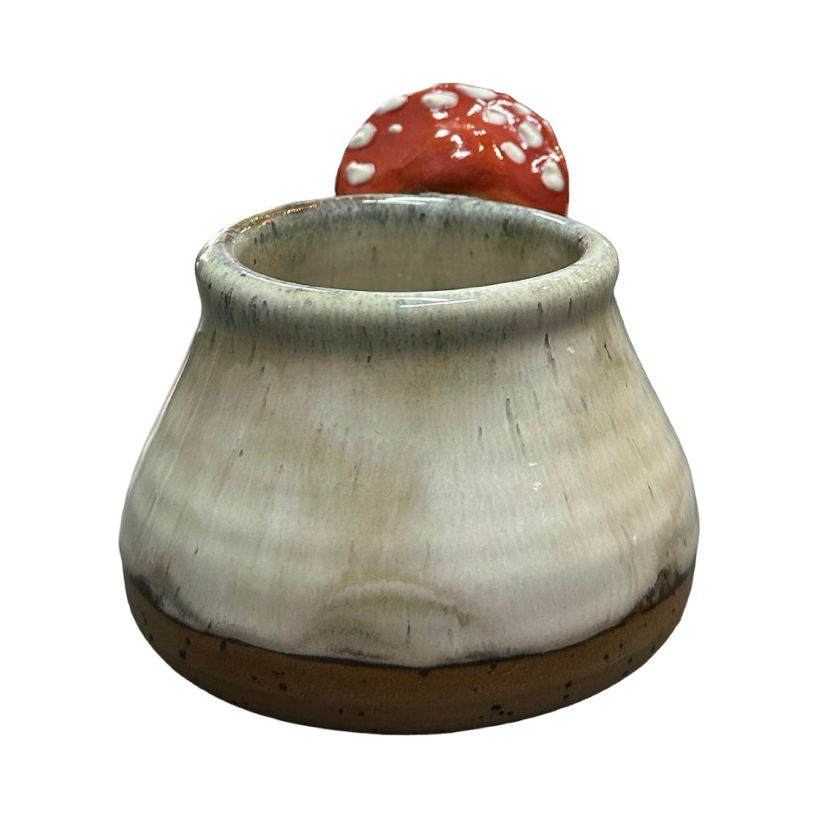Ceramic mug with a red mushroom on a white background.