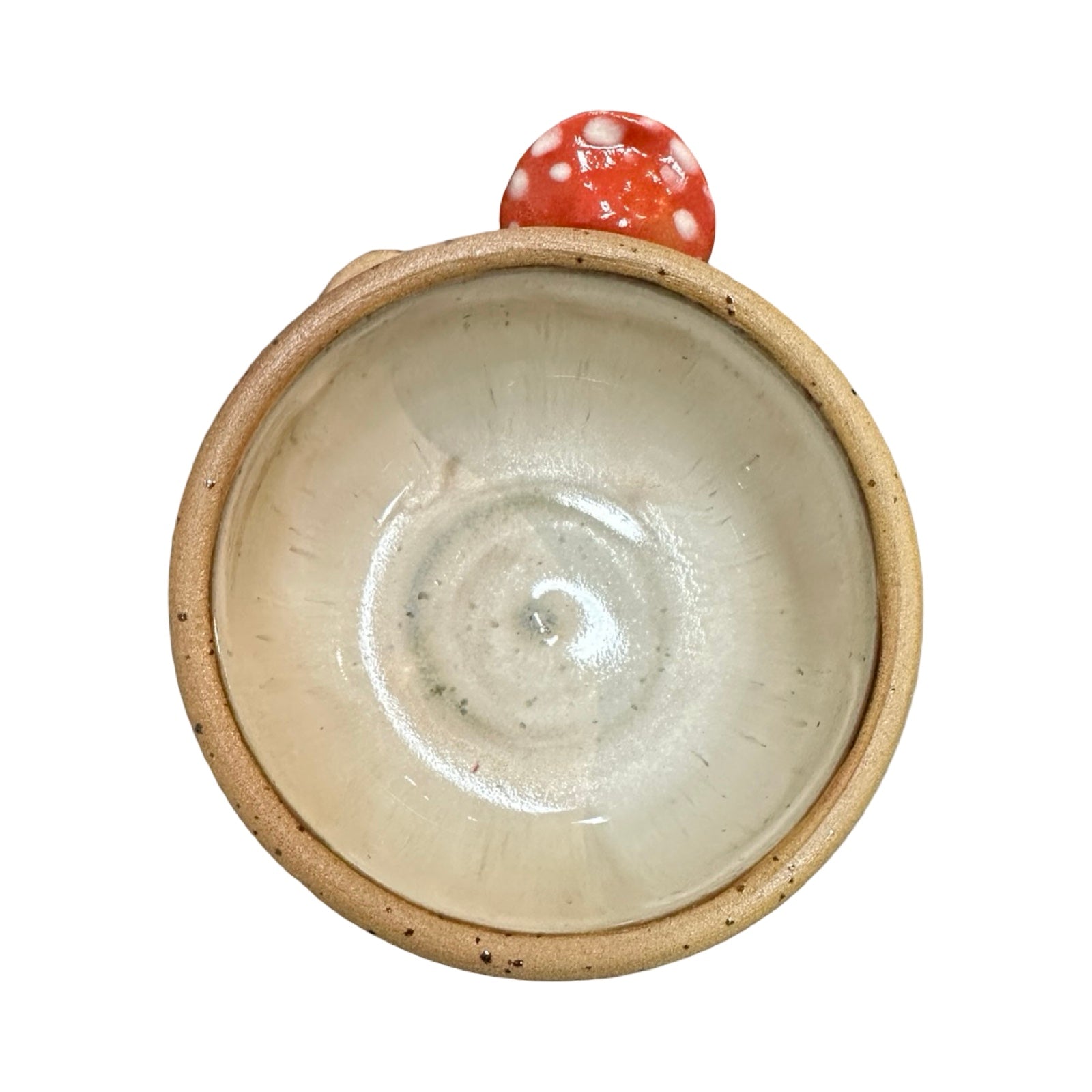 Ceramic bowl with a red and white mushroom design on a white background.