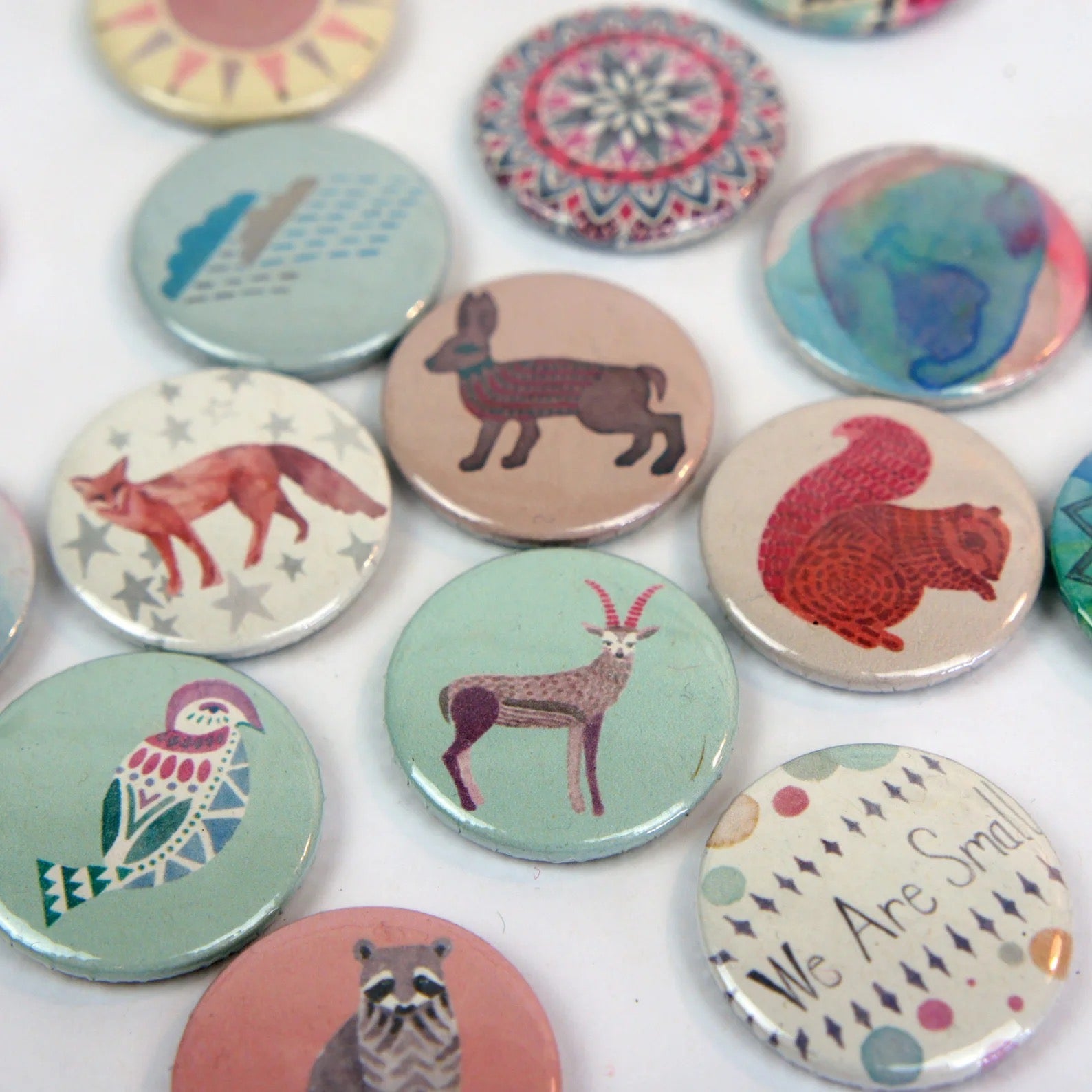 Collection of colourful badges with animal illustrations on a white background.