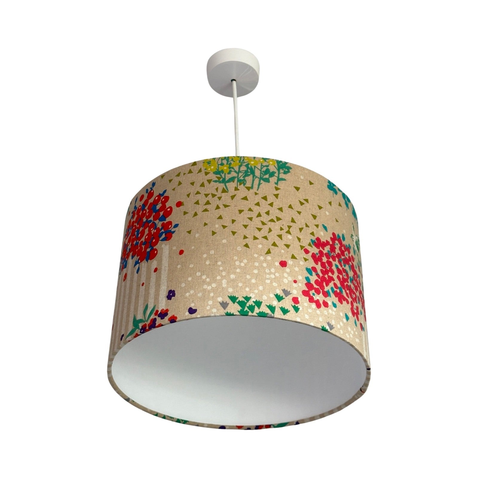 Drum lampshade with colourful clusters of berries and flowers, green and white birds and white stripes on a cream background