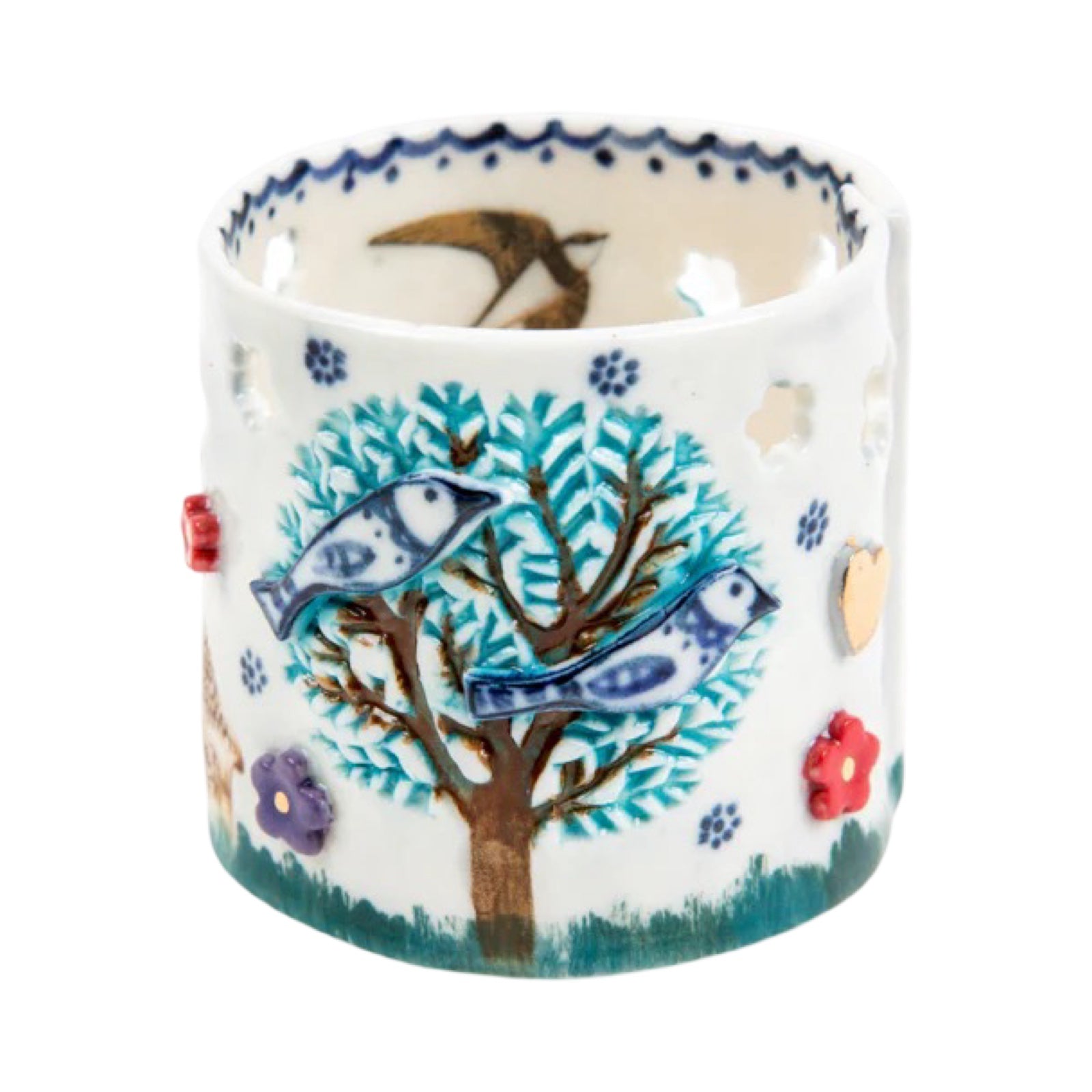 Decorative ceramic tea light holder with bird and tree design on a white background.