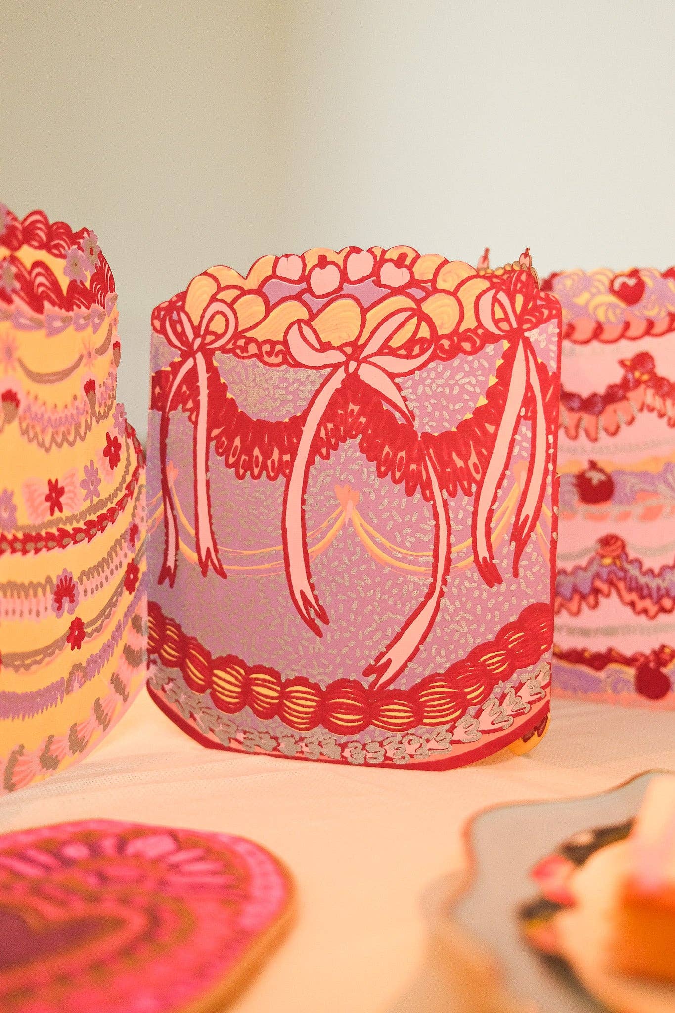 Decorative cake with pink and orange design on a white background.