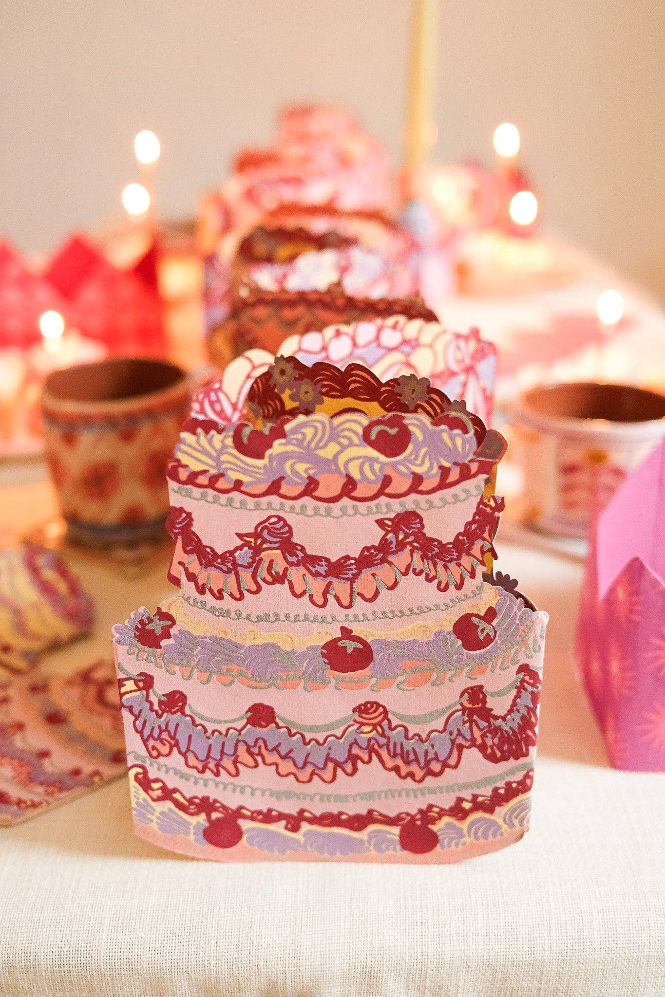 Decorative cake with intricate designs on a table with blurred background.