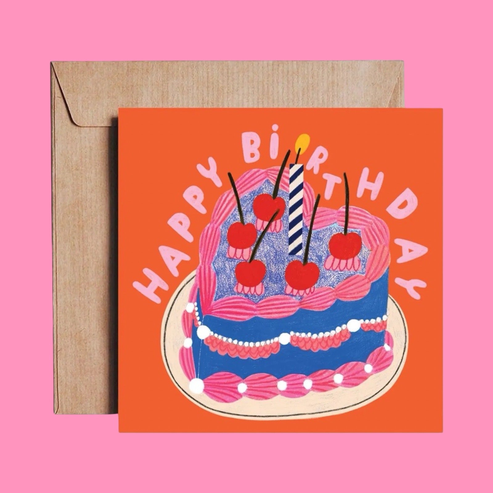 Birthday card with cake illustration and 'Happy Birthday' text on an orange background, with a brown envelope.