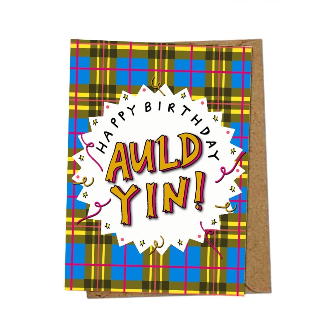 Birthday card with the text 'Happy Birthday Auld Yin' inside a white pointy-edged circle on a blue and yellow tartan background.