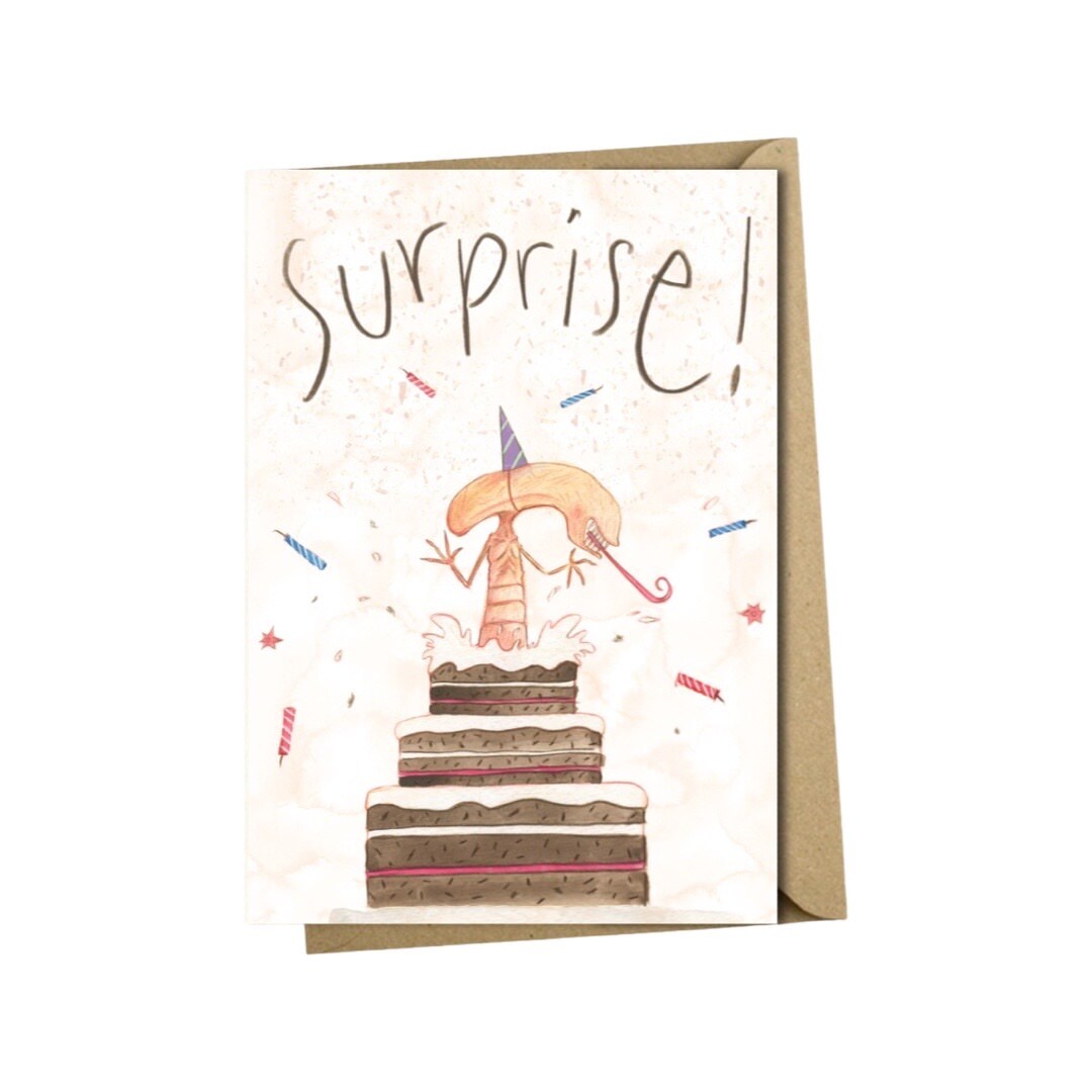 Birthday card featuring an illustration of an alien bursting out of a birthday cake, inspired by the classic film Alien.
