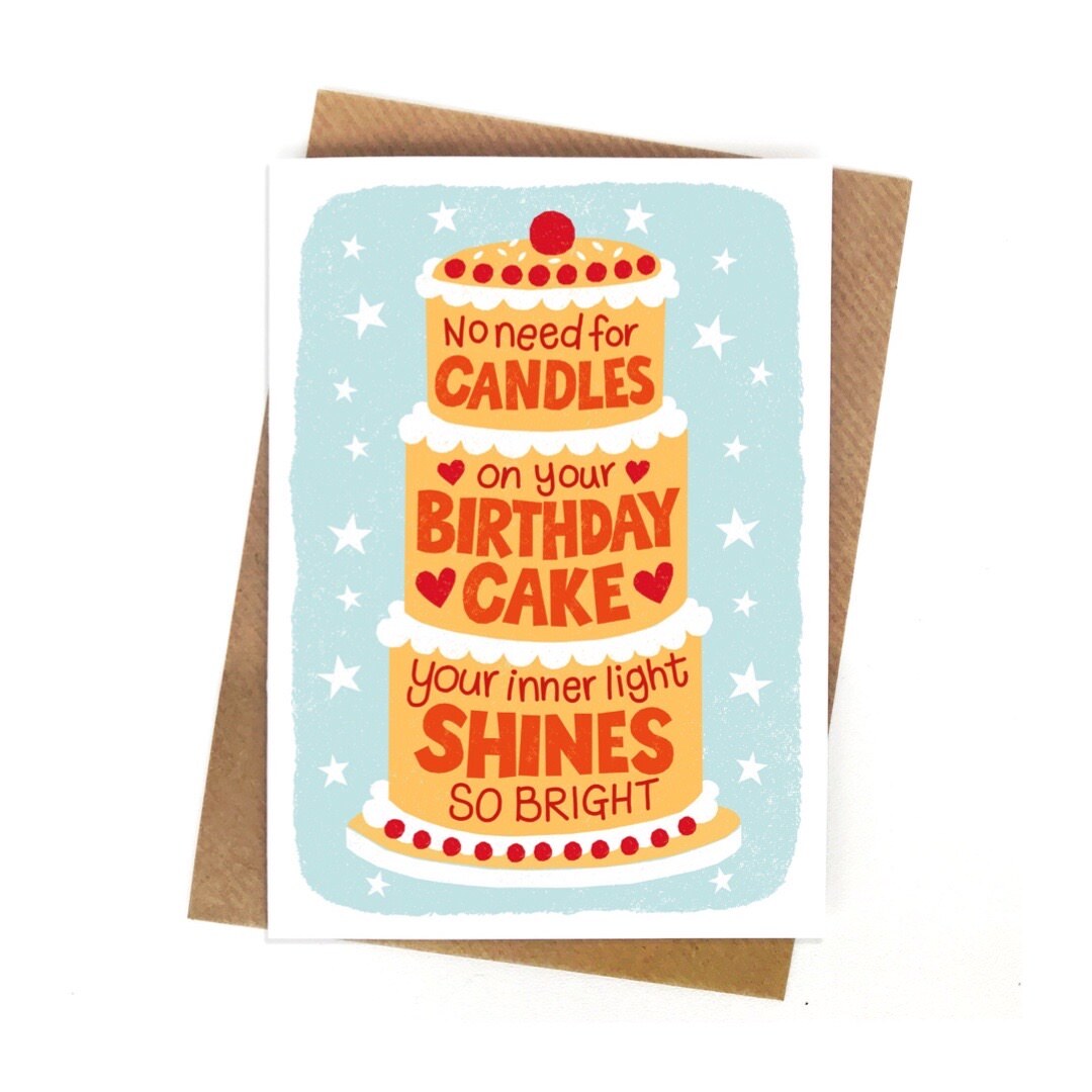 A birthday card with a huge yellow cake with white icing and a cherry on top with the text' no need for candles on your birthday cake your inner light shines so bright' written inside the cake, all against a pale blue background with white stars.