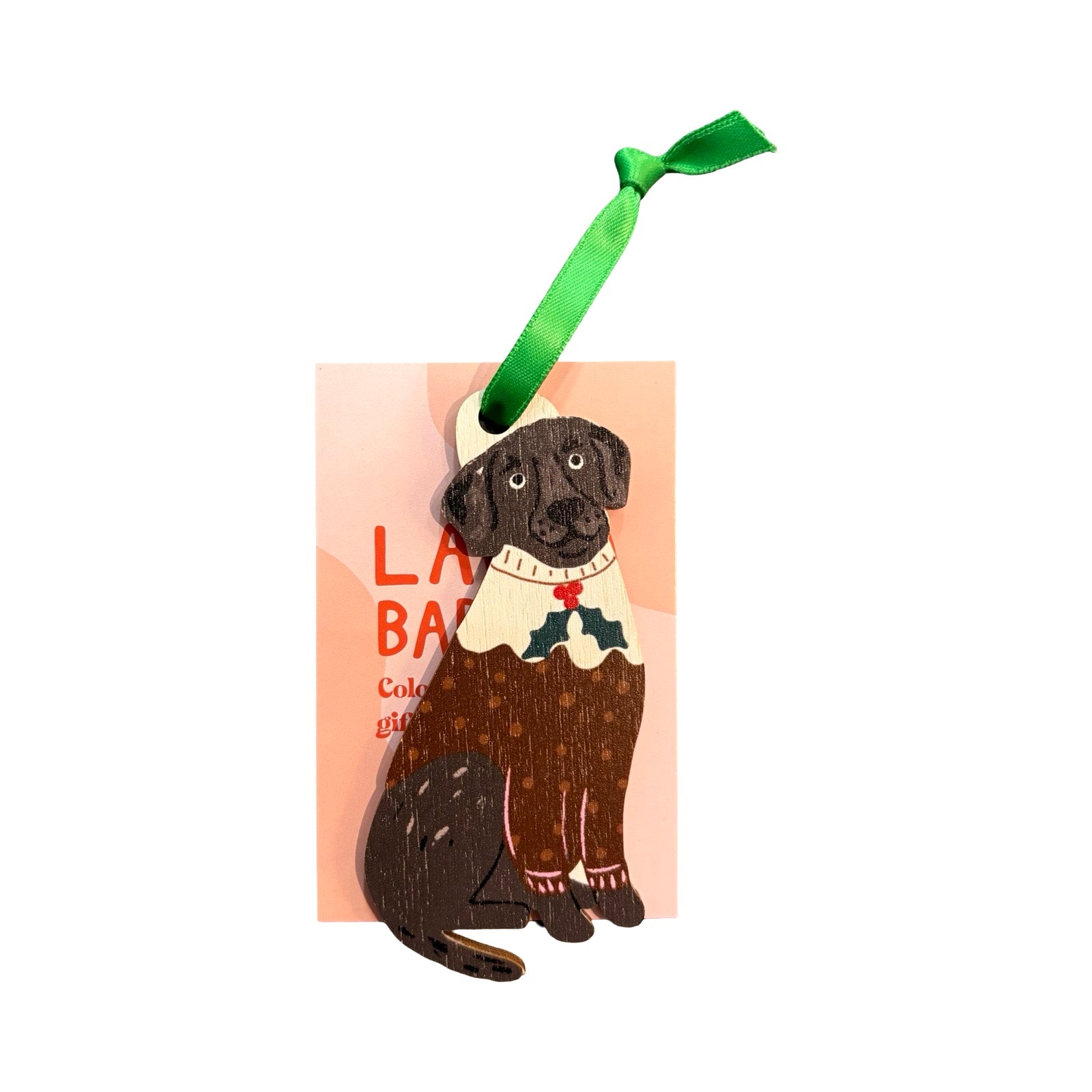 Dog ornament with a sweater and green ribbon on a white background.