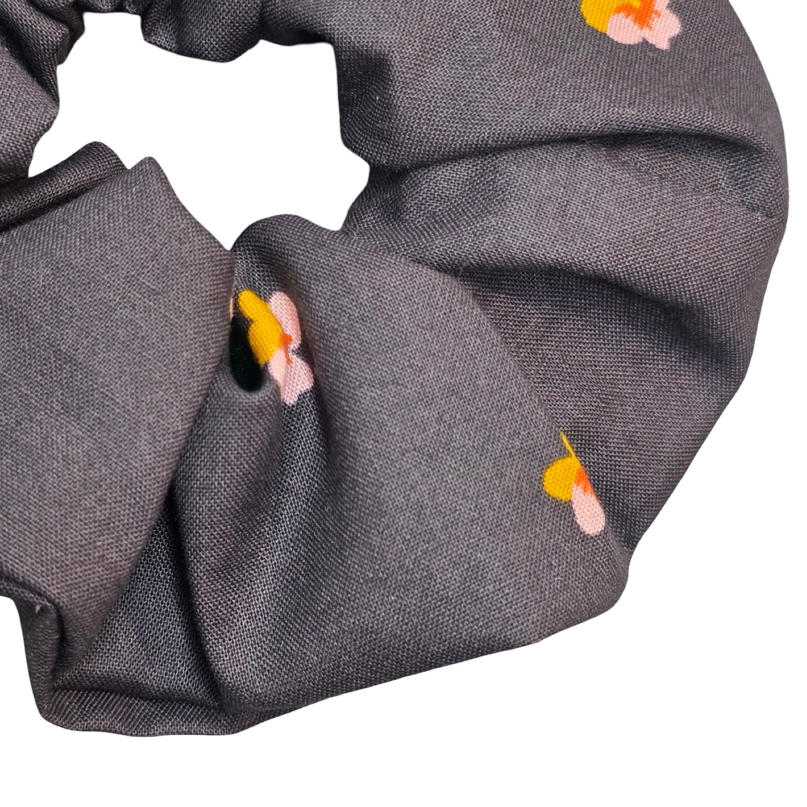 This black handmade hair scrunchie is made from 100% cotton fabric with pink and yellow violets.