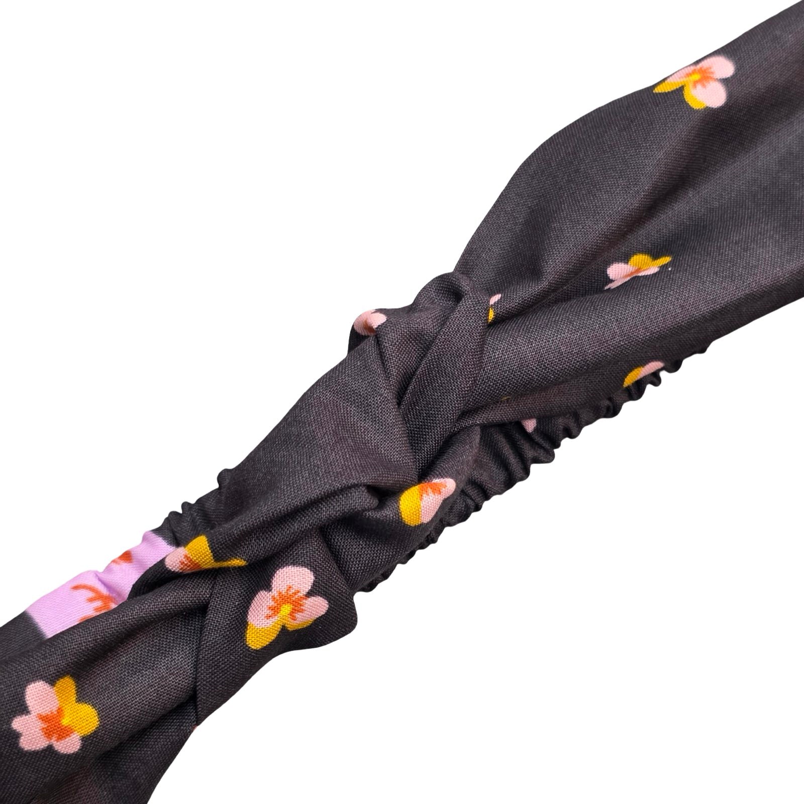 This handmade black floral knotted headband is made from 100% cotton fabric with pink and yellow violets.