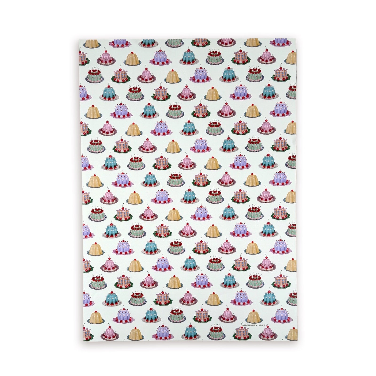 Patterned paper with small cake illustrations on a white background.