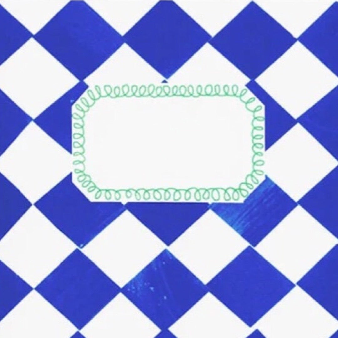 A close up of a notebook featuring a blue and white diamond pattern background with a central white rounded rectangle outlined in light green scribbled border.