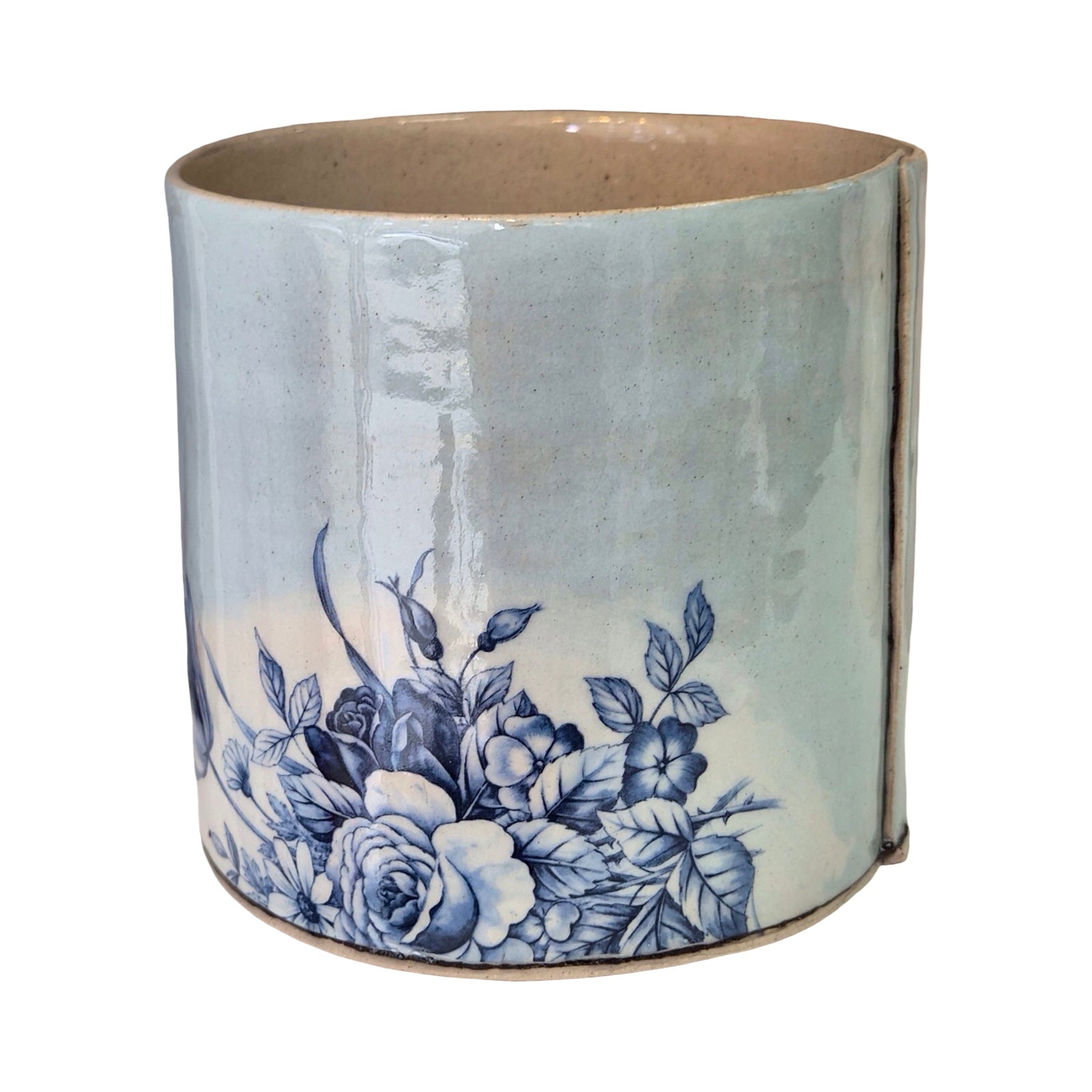 Ceramic planter with blue floral design on a white background.
