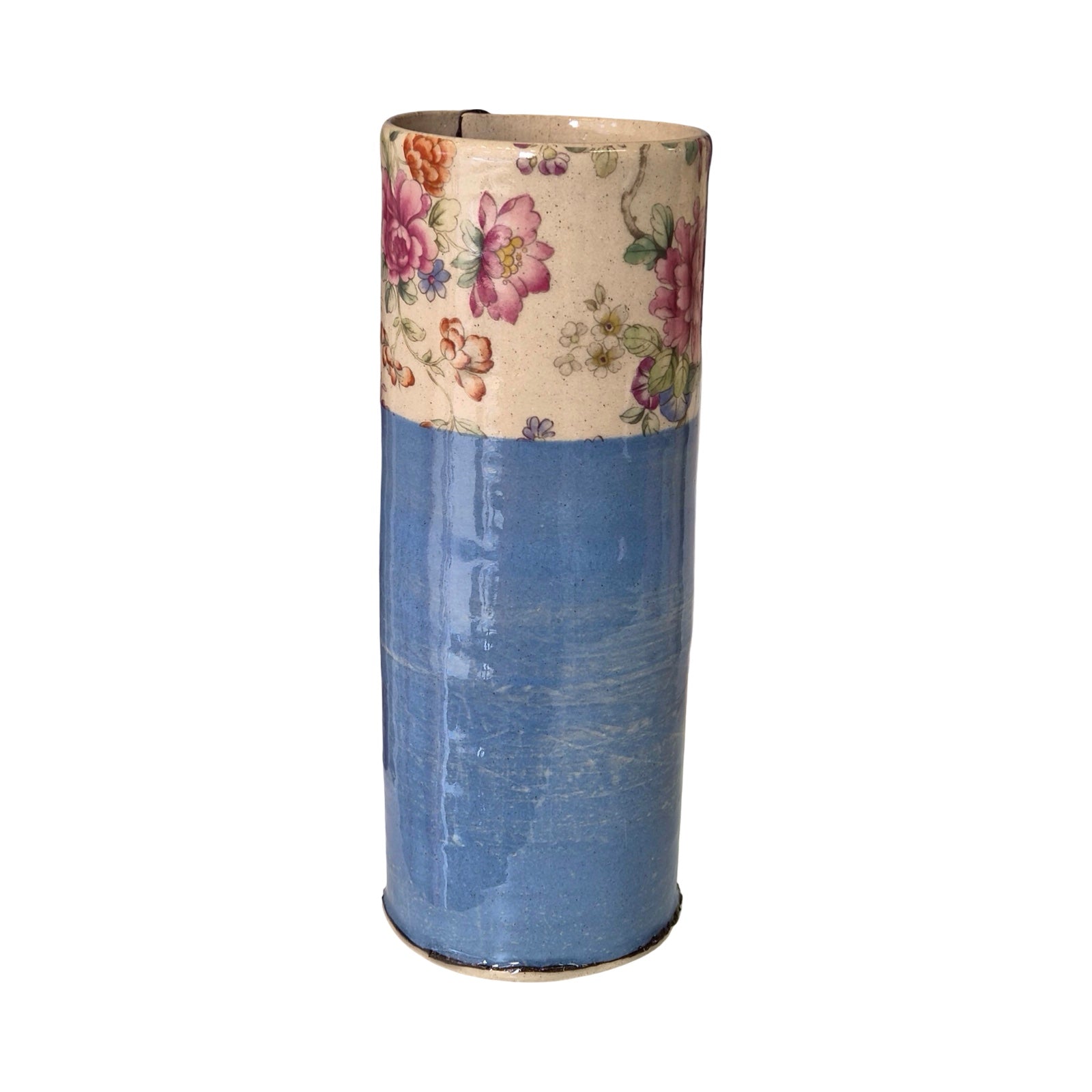 Blue cylindrical vase with floral-patterned top on a white background.