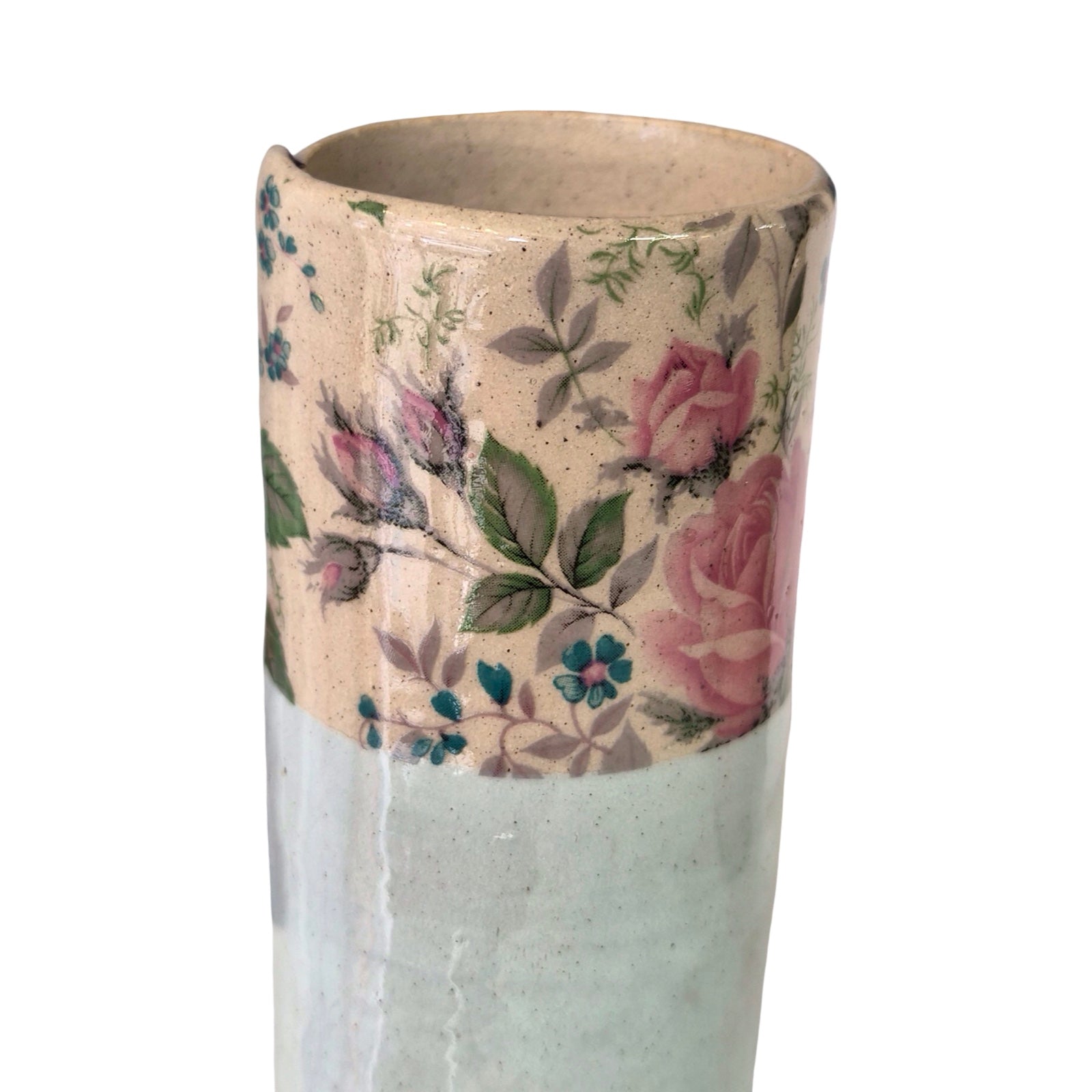 Cylindrical vase with floral pattern on a white background.