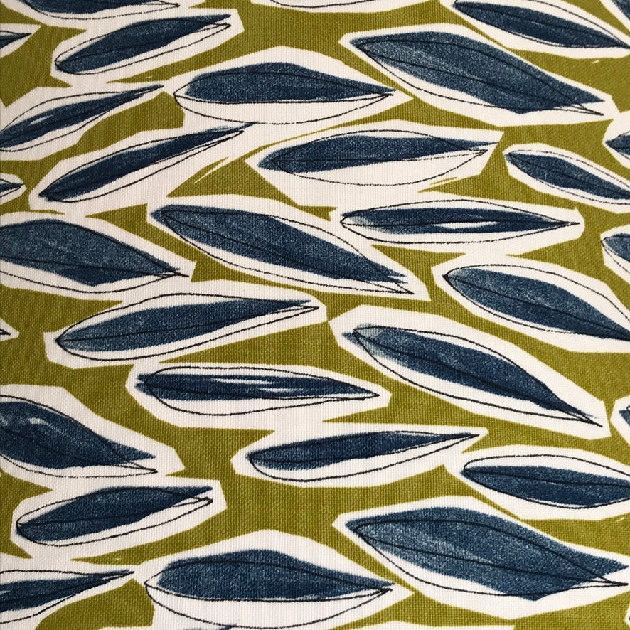 Dull lime green fabric with blue leaves with white surroundings.