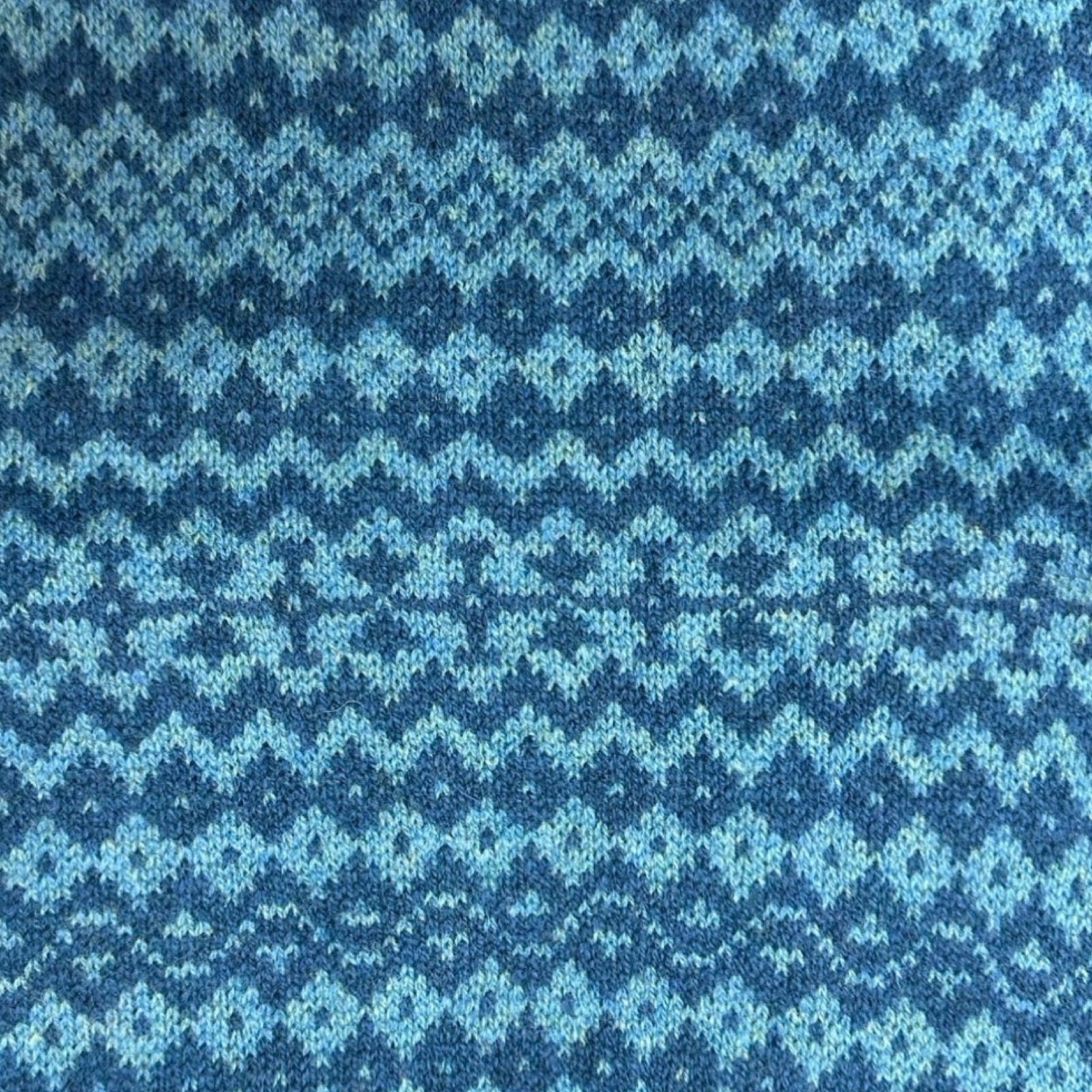 Super soft and cosy 100% lambswool knitted snood in a turquoise and blue geometric stripes design.