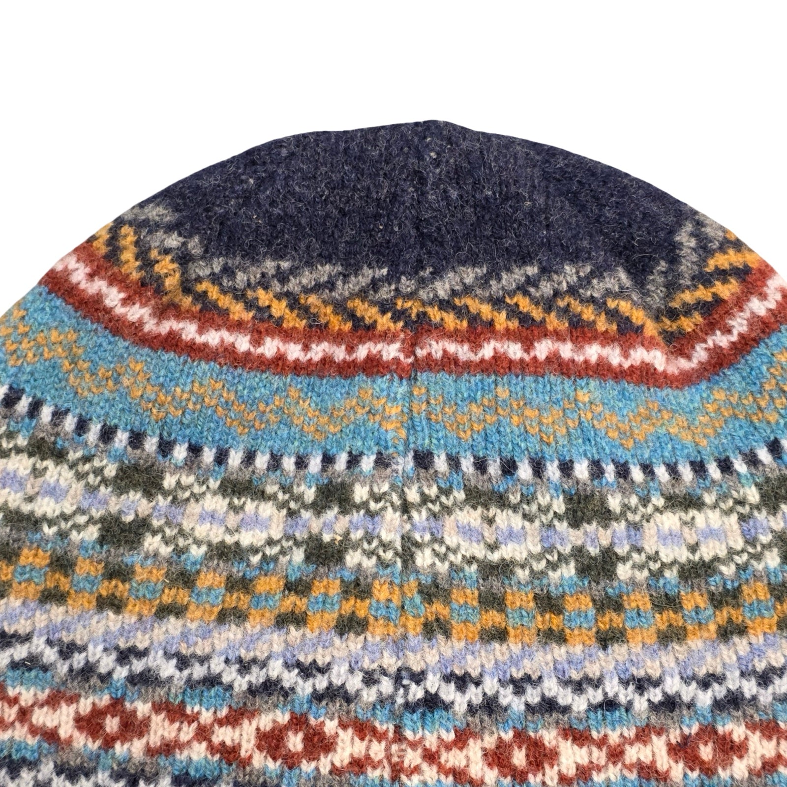Knitted hat with a colorful pattern on a white background.