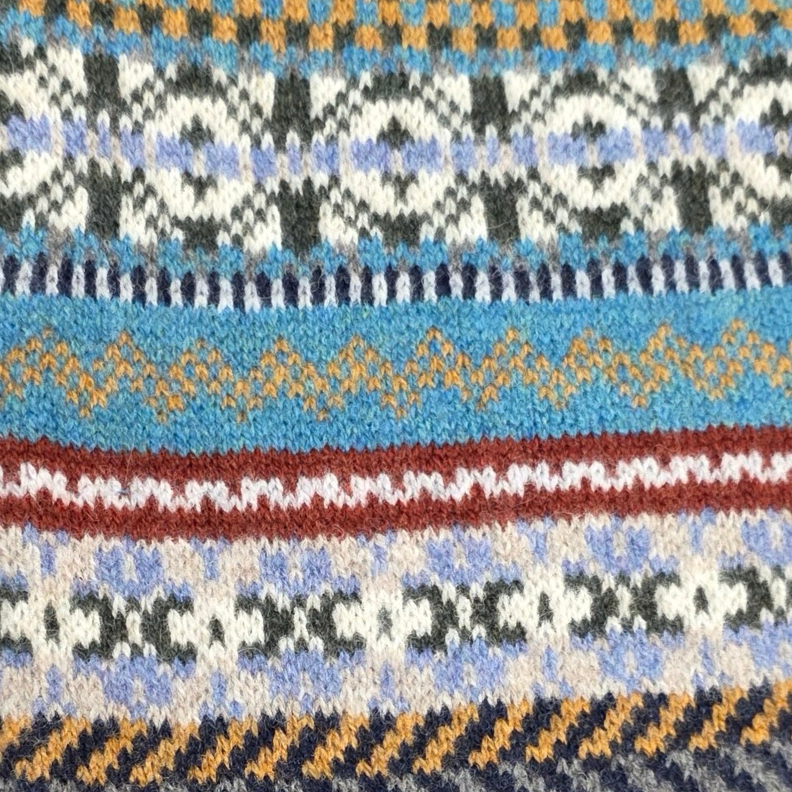 Close-up of a patterned fabric with blue, brown, and white colors.