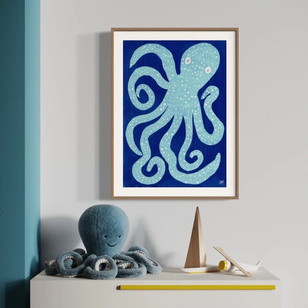 Framed artwork of an octopus on a wall above a shelf with toys.