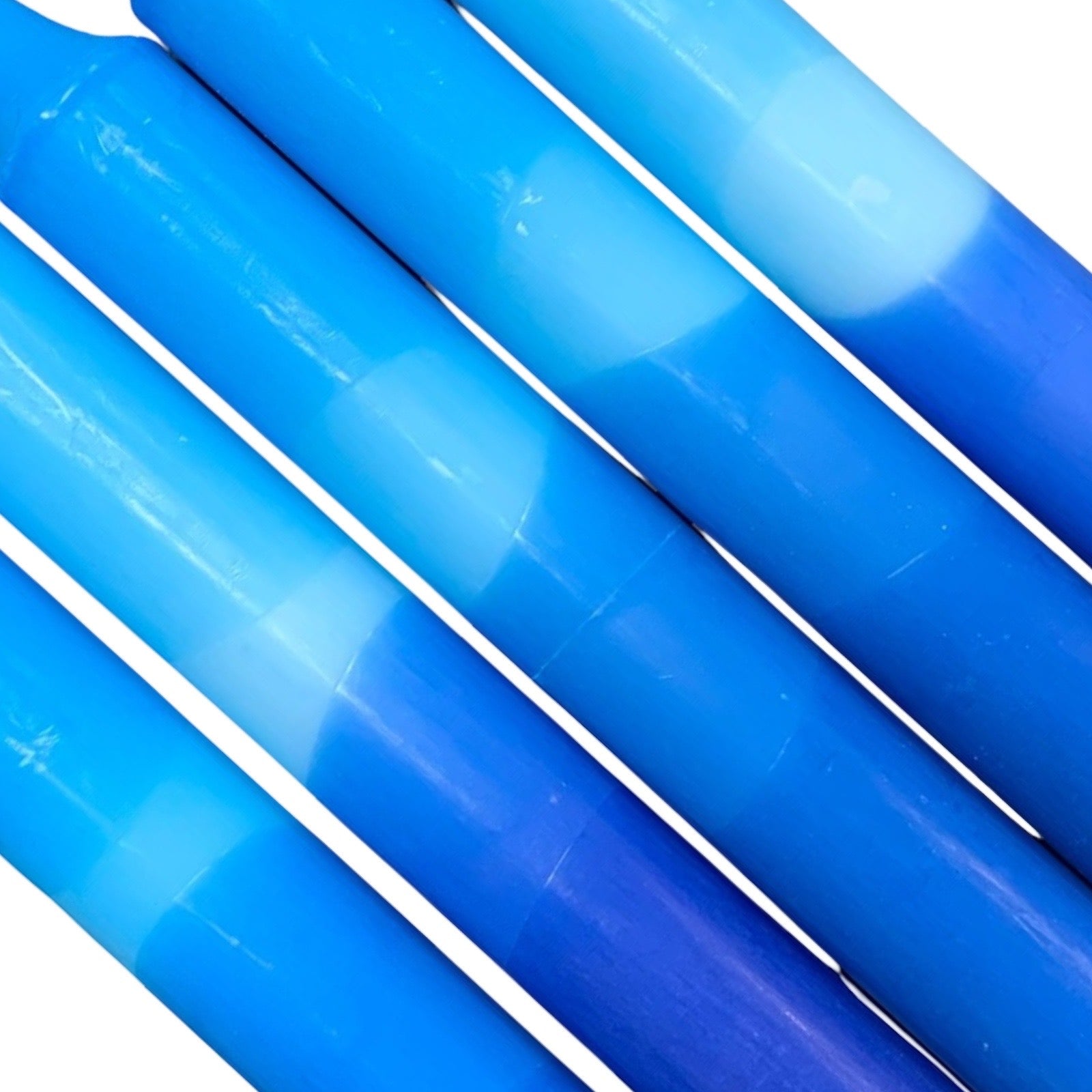 A row of 5 handmade dinner candles with a dark blue base and lighter blue top.