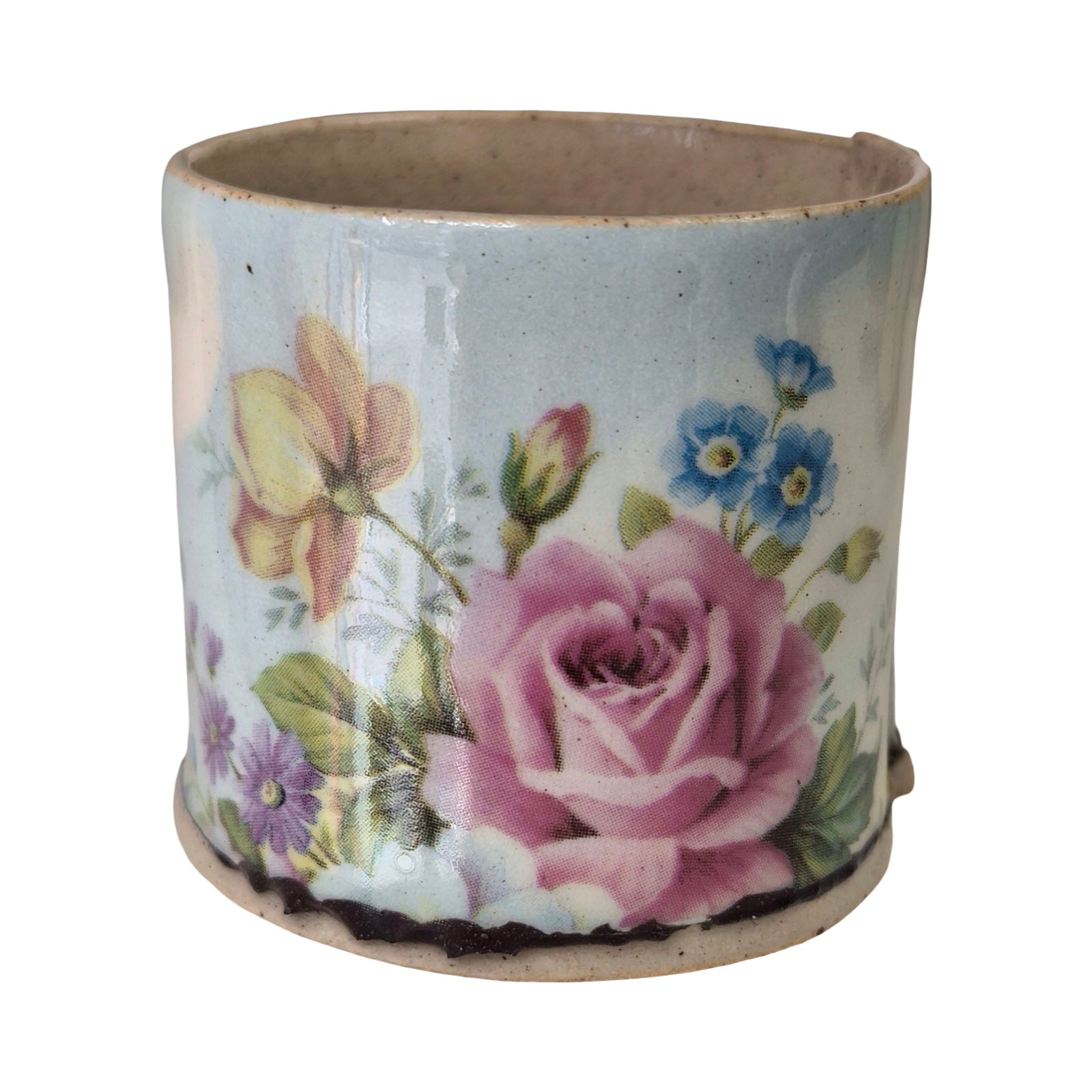 Ceramic planter with floral design on a white background.