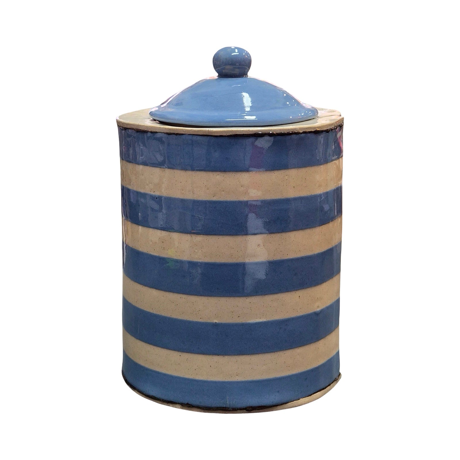 Ceramic jar with blue and beige stripes on a white background.