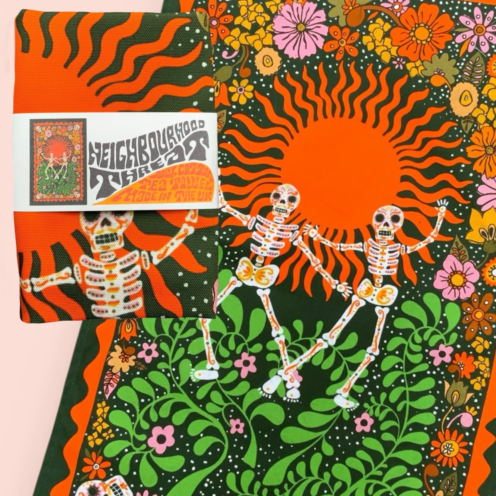 Colourful fabric with skeletons, flowers, and a sun design, featuring a 'Neighborhood Threat' logo.