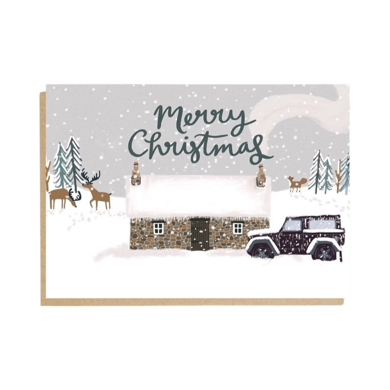 Christmas card featuring an illustration of a snow-covered bothy and landrover with reindeer and trees behind and the text 'Merry Christmas'.