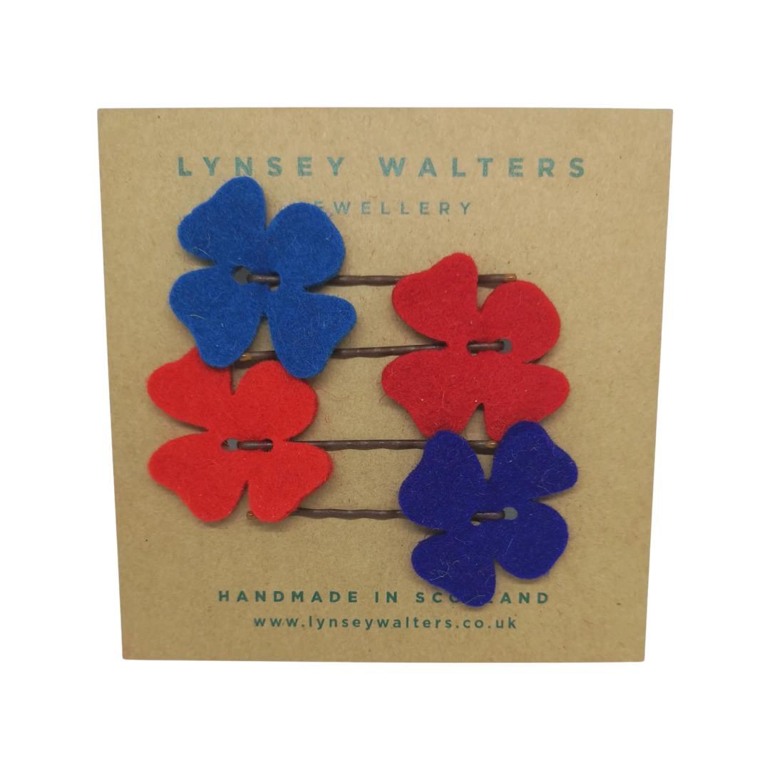 Add a little pop of colour to your hair with these gorgeous floral hair slides. 4 pack, 2 red and 2 blue. 